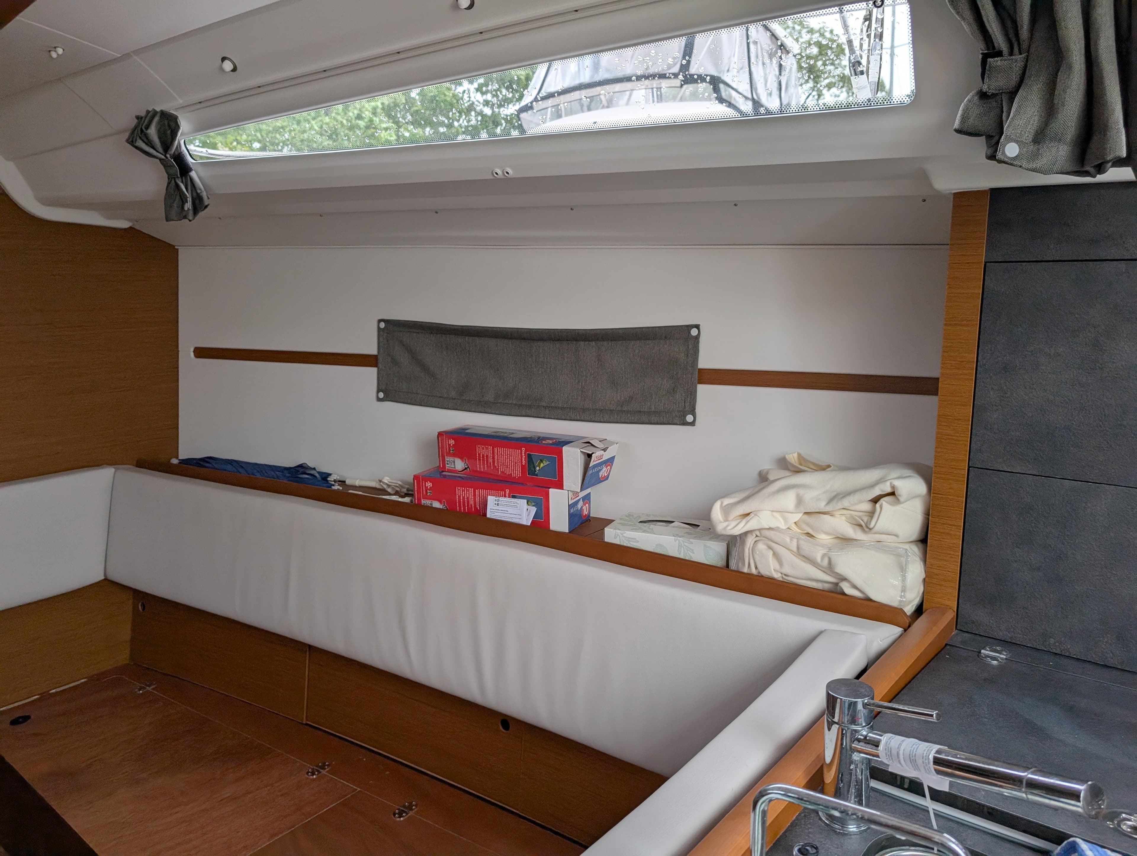 Interior of 2021 Jeanneau Sun Odyssey 349 sailboat with seating and storage.