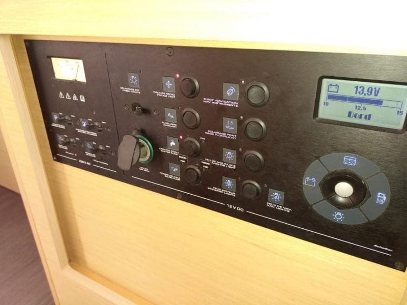 Control panel of a 2017 Lagoon 42 yacht, featuring various switches and a digital display.