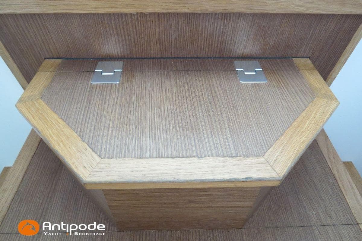 Wooden yacht interior detail with hinges, featuring Antipode Yacht Brokerage logo. Meta JPB 52, 2021.