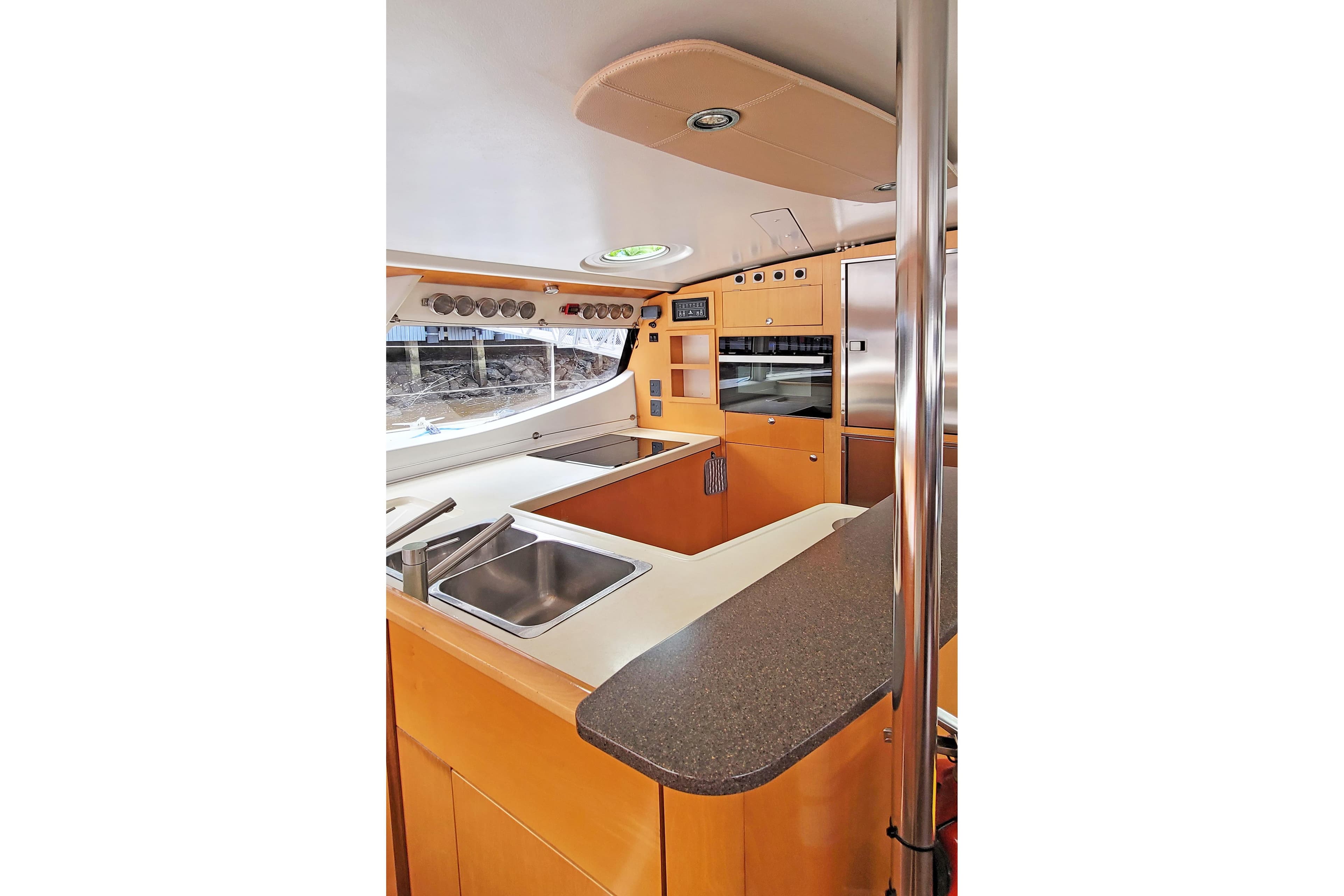 Modern kitchen interior of 2007 Fountaine Pajot Salina 48 catamaran, featuring sleek countertops and appliances.