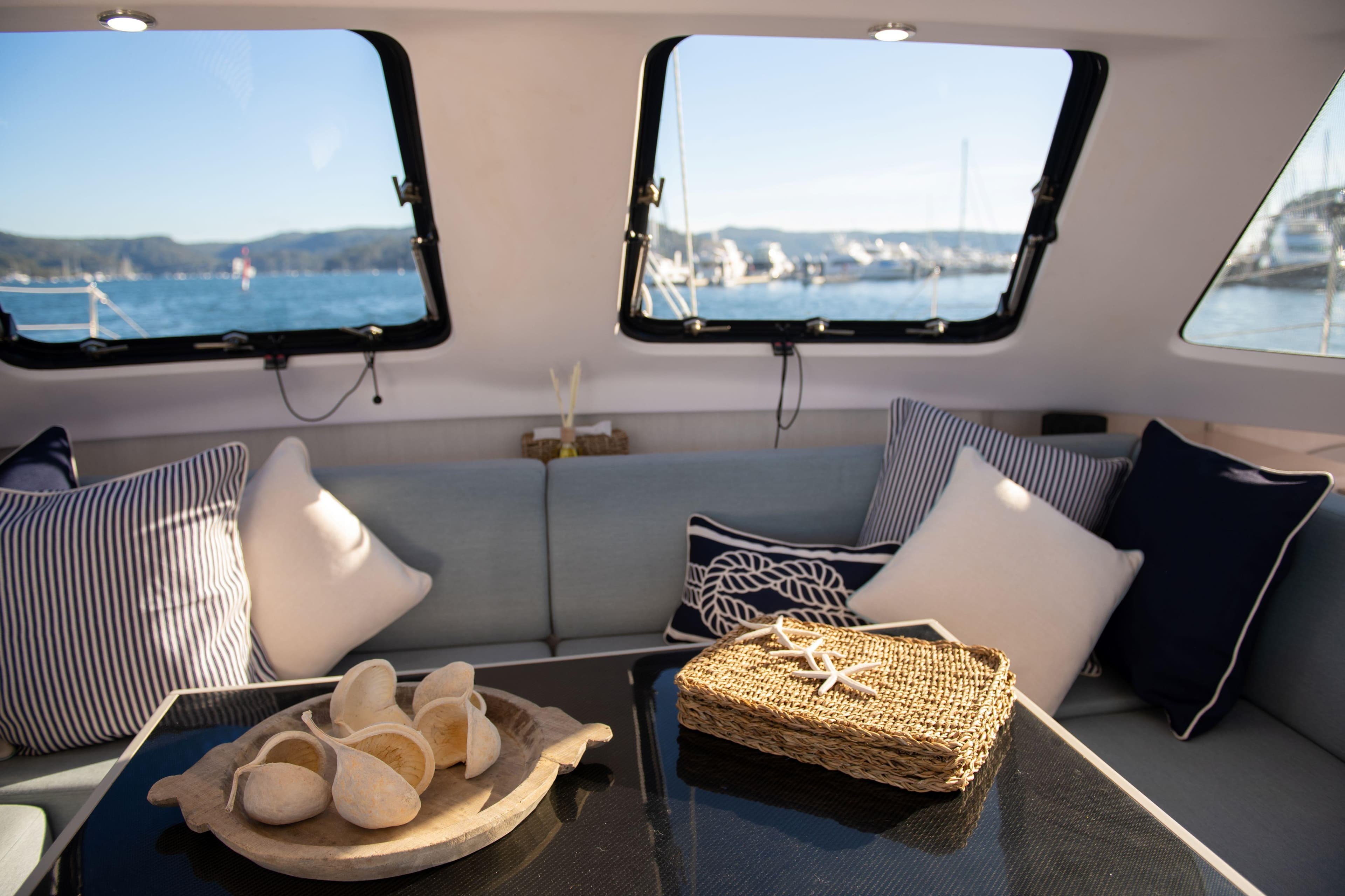 Interior of 2019 Seawind 1190 catamaran with cozy seating and nautical decor.