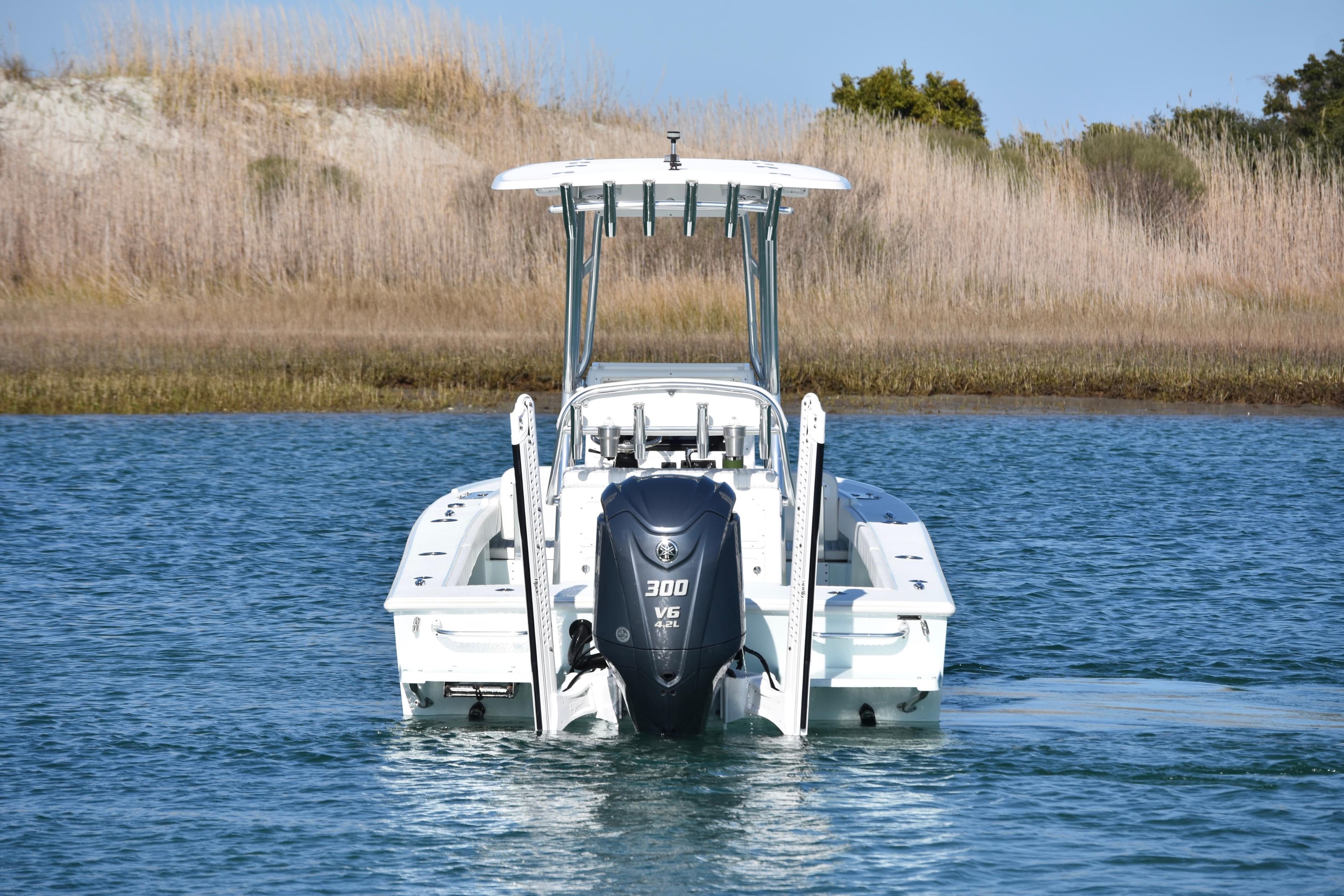 2023 Dorado 25 boat with powerful outboard motor on calm water.