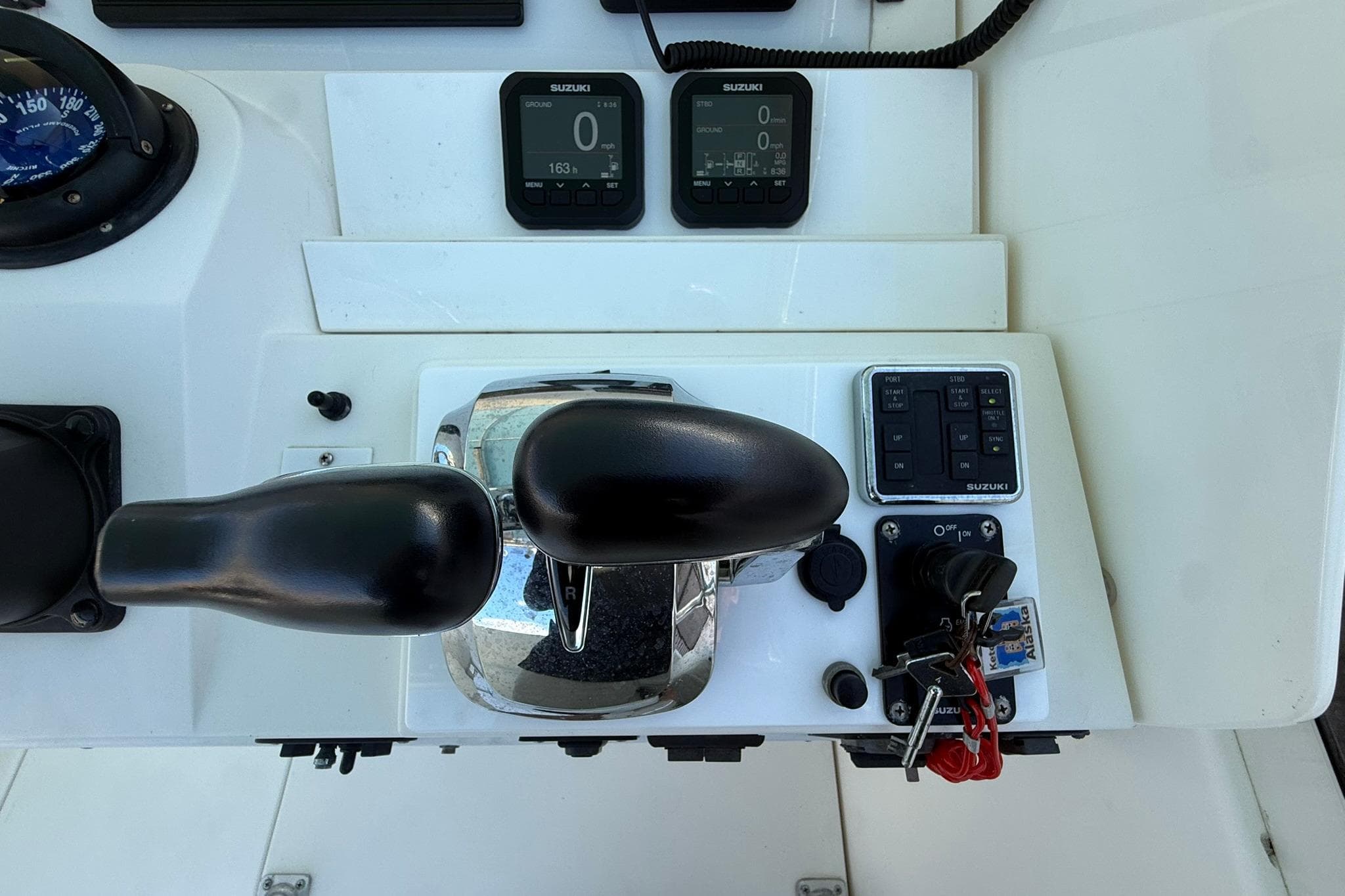 Control panel of a 1998 Contender 35 Express boat with Suzuki instruments.