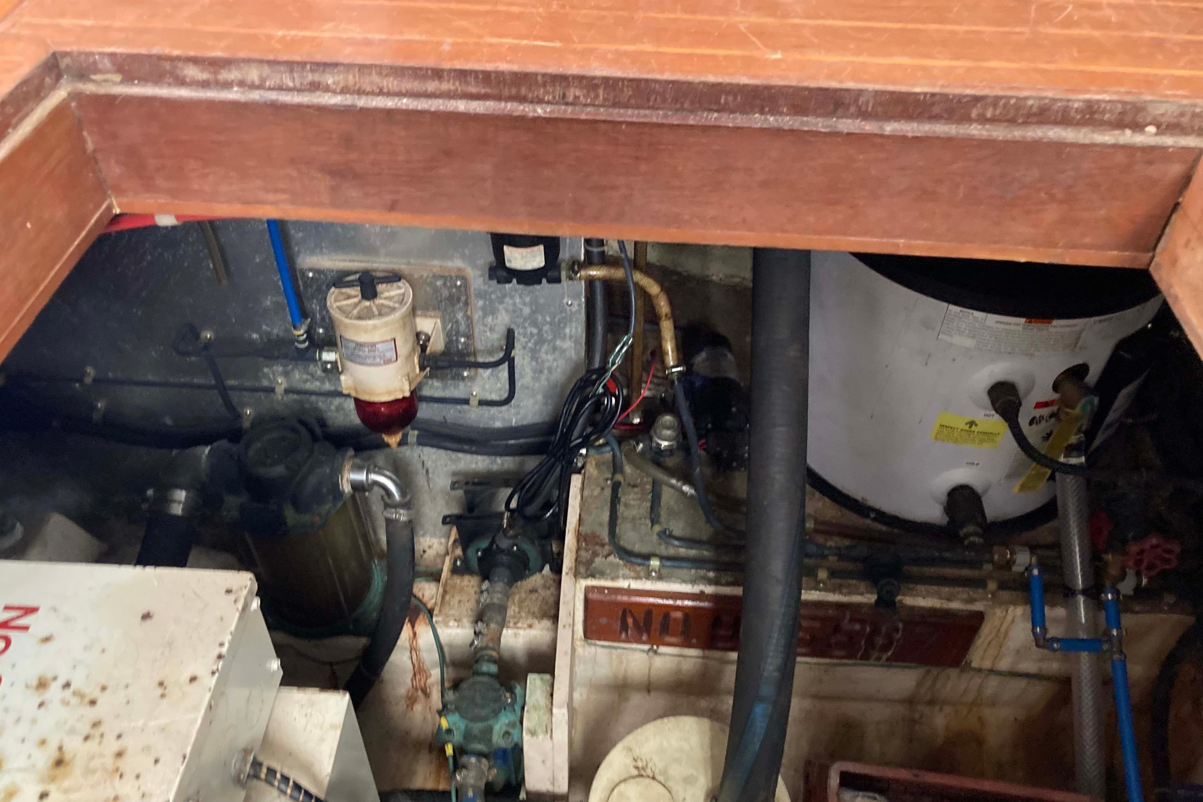 Engine room of a 1988 Albin 43 Trawler, showing mechanical components and wiring.