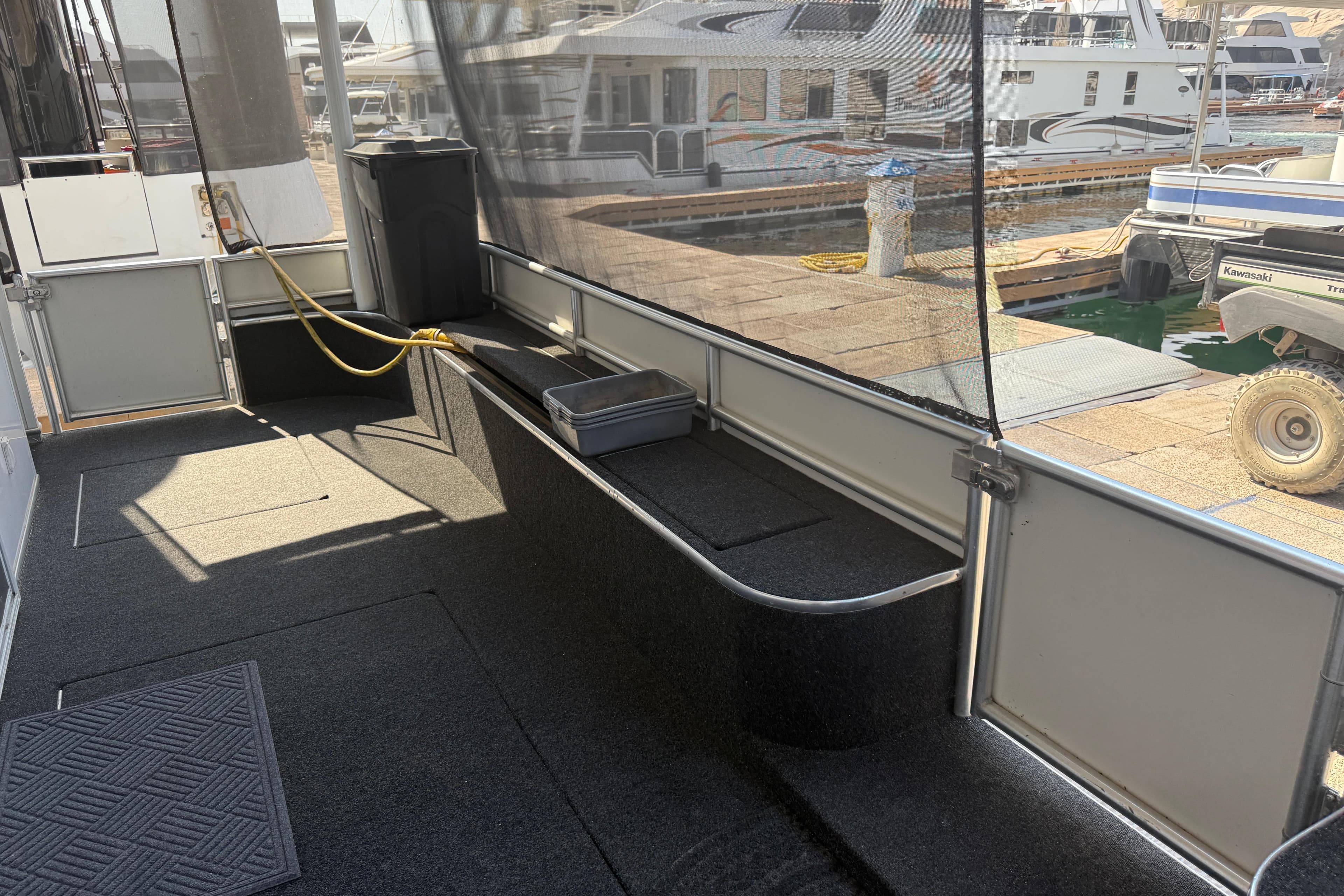 Enclosed deck area of 2015 STARDUST Oceans Share #2 houseboat at marina.