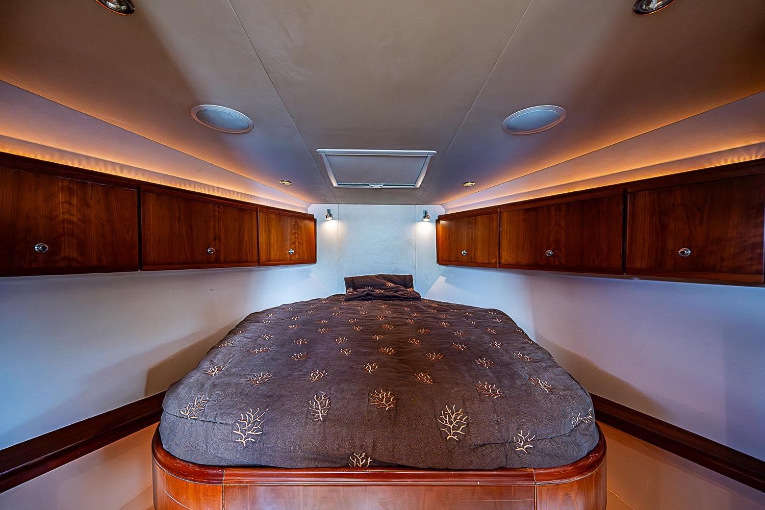 Luxurious cabin interior of a 2008 Bertram 360 yacht with elegant wood cabinetry.