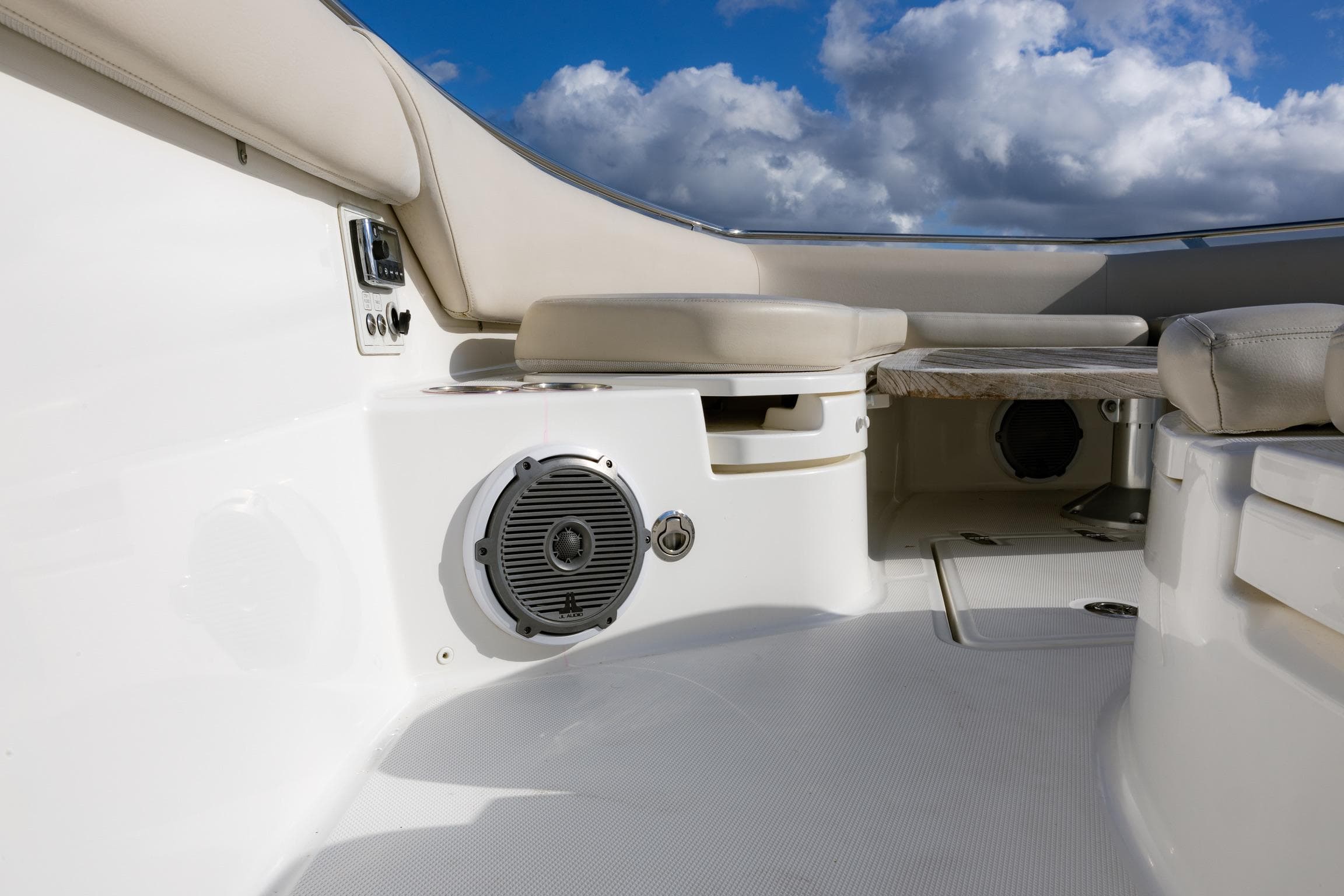 2017 Boston Whaler 420 Outrage interior with seating and speaker, under a cloudy sky.