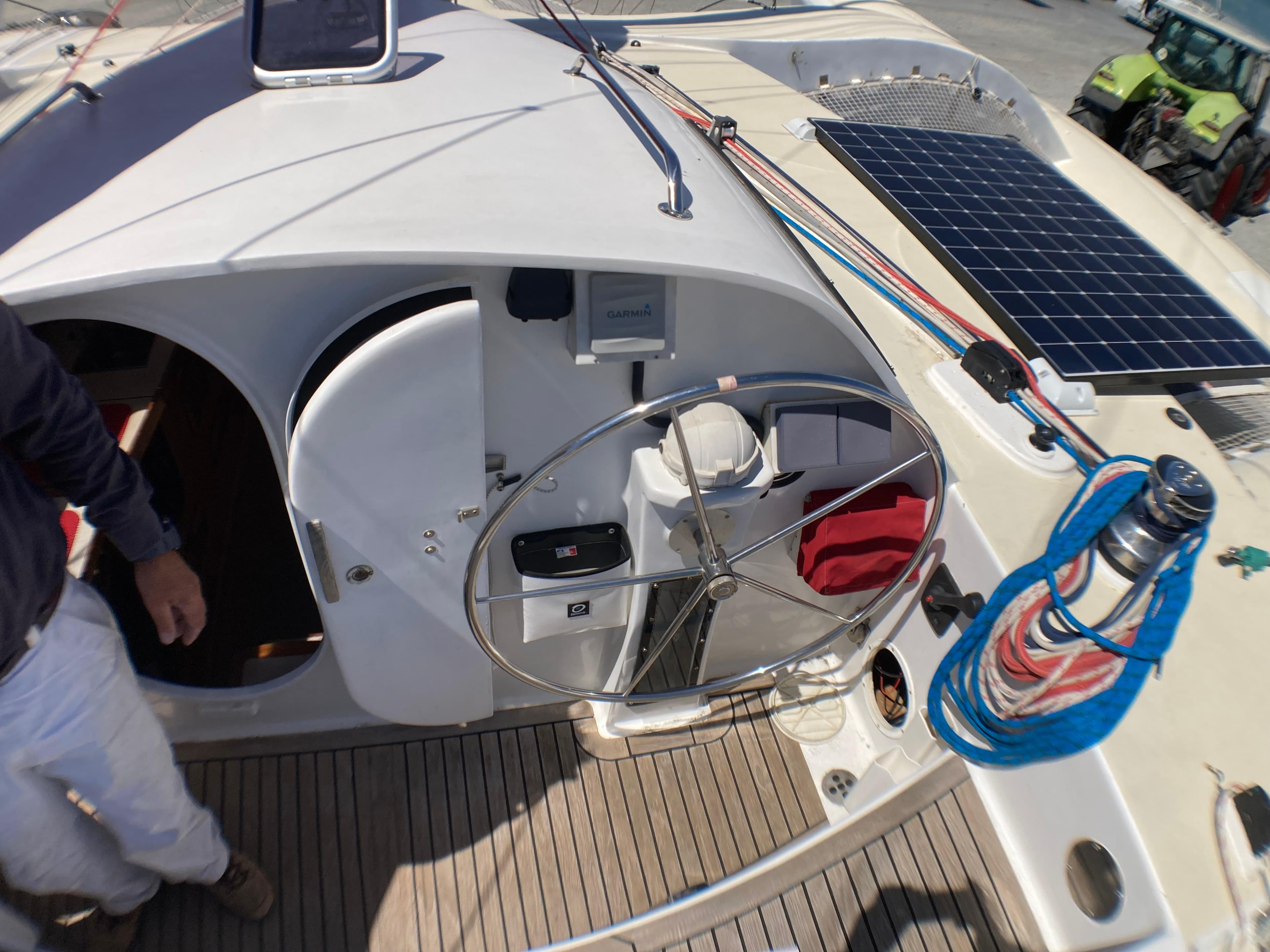 Cockpit of 2002 Custom TRIMARAN POLYNESIA 45 with steering wheel and solar panel.