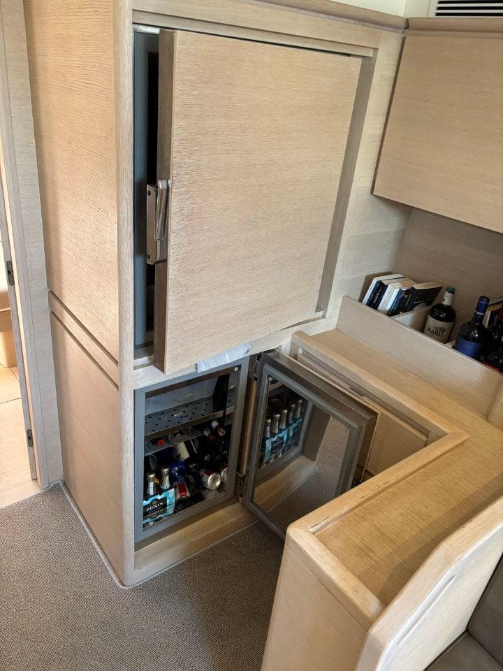 Luxurious interior of 2016 Solaris 58 yacht with open cabinets and beverage storage.