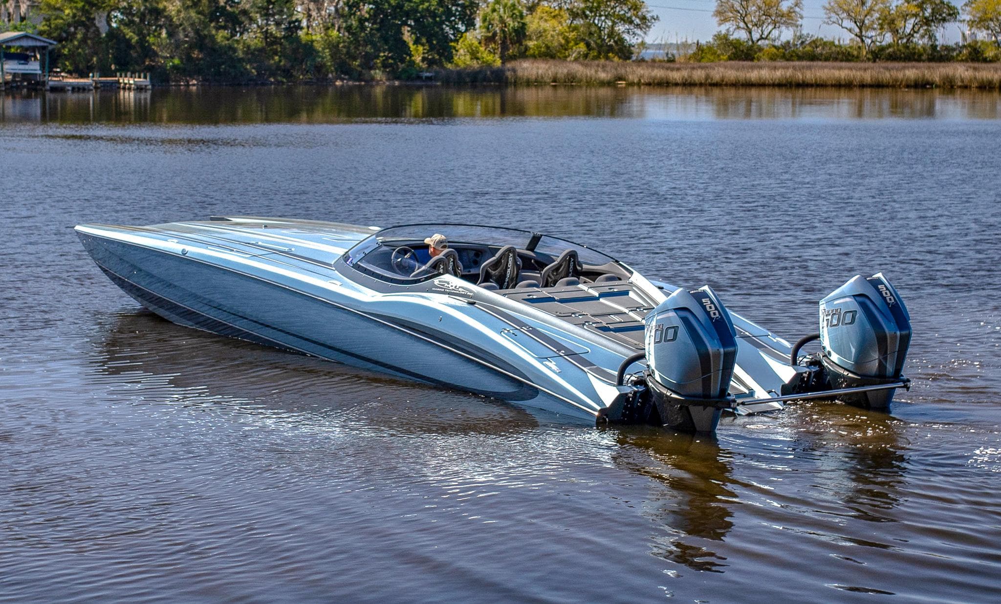 2024 MTI 390X speedboat with dual engines on a calm lake.
