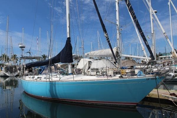 1973 Nautor Swan 44 sailboat docked in marina, featuring a blue hull and white deck.