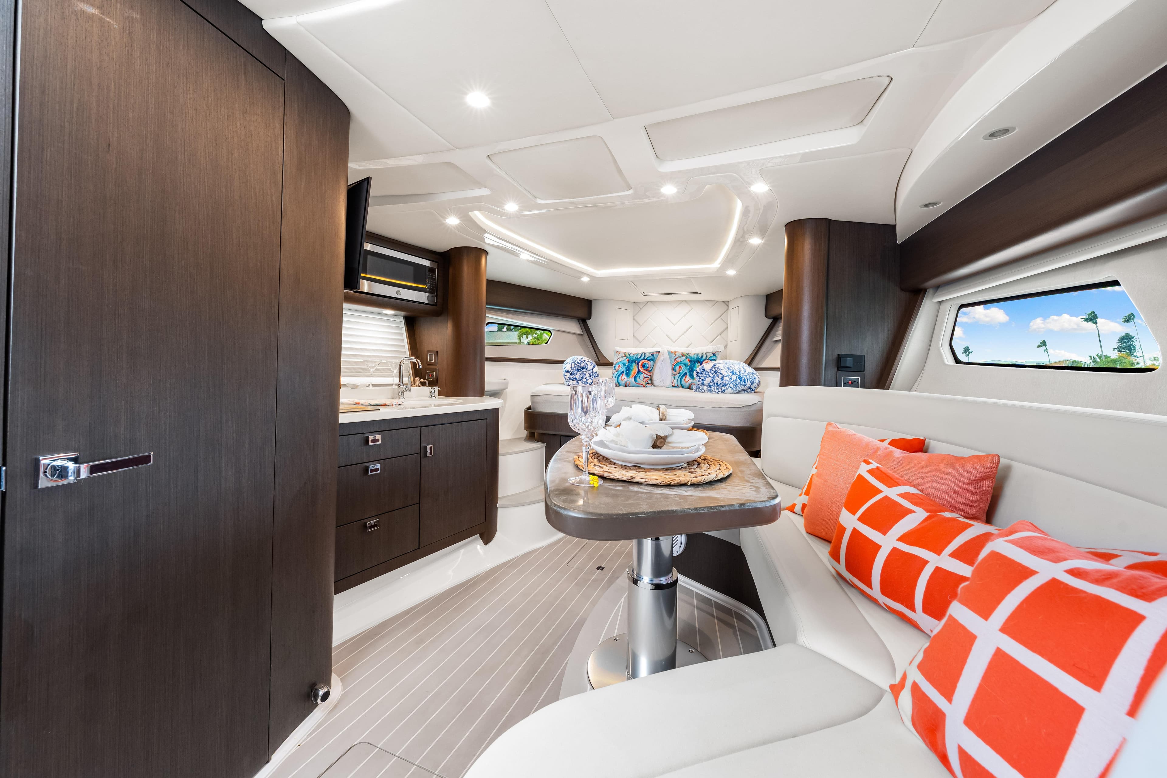 Luxurious interior of 2019 Intrepid 410 Evolution yacht with modern kitchen and cozy seating area.