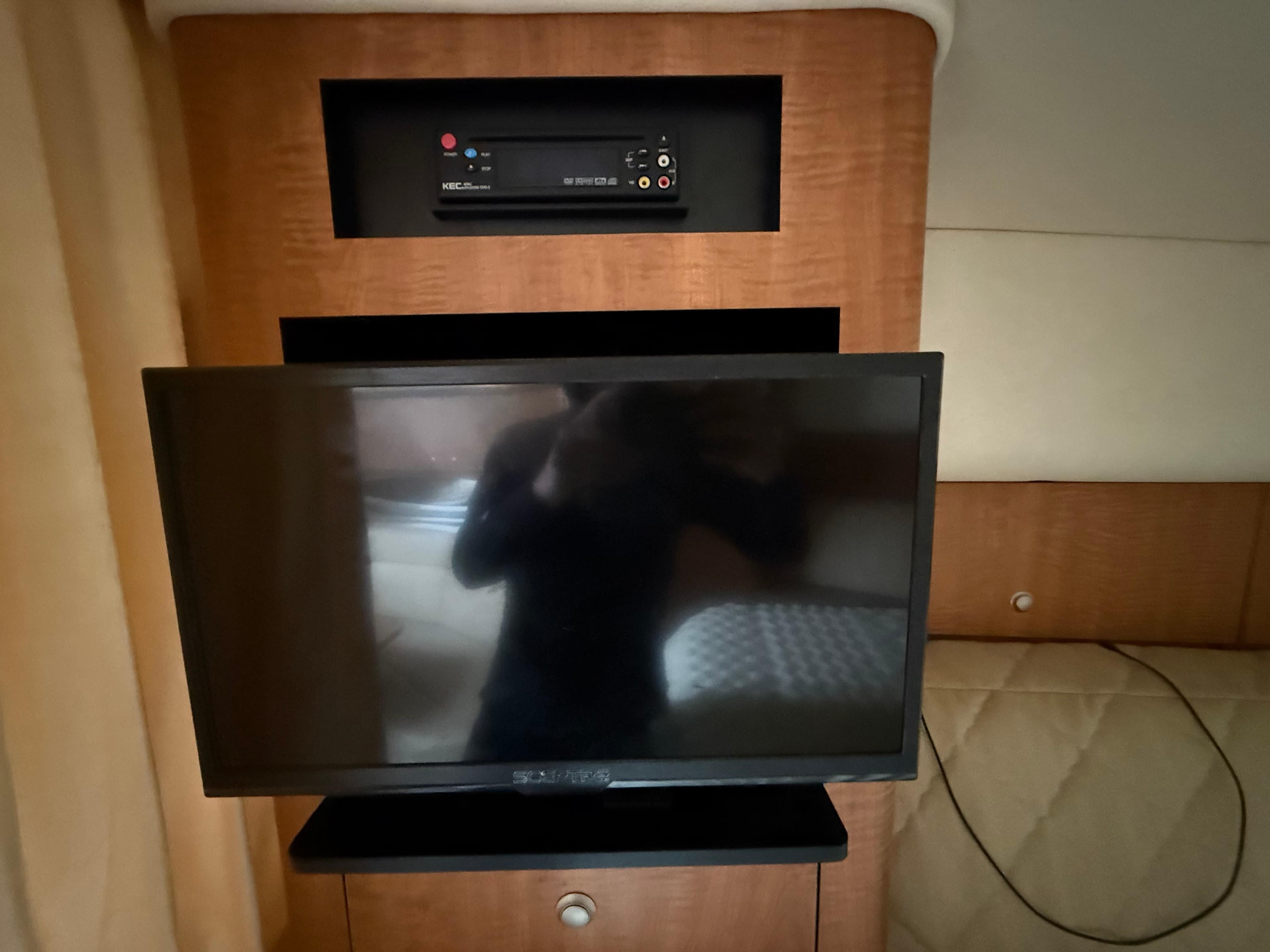 Interior of 2006 Sea Ray 320 Sundancer with TV and audio system.
