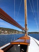 Anker & Jensen 8mR sailboat from 1914 on calm waters.