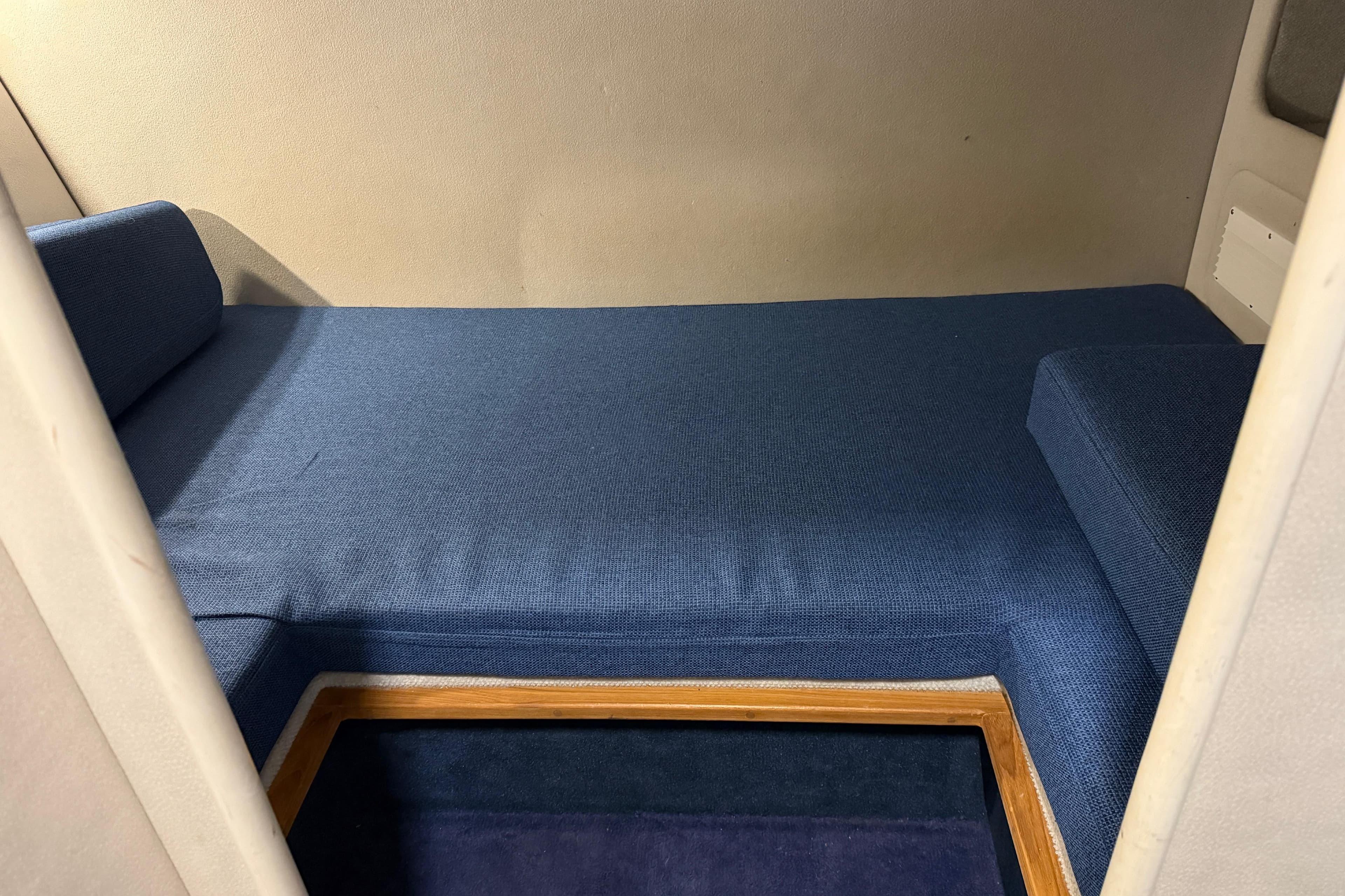 2006 Monaro 27 SE/SX interior cabin with blue upholstery and wooden trim.