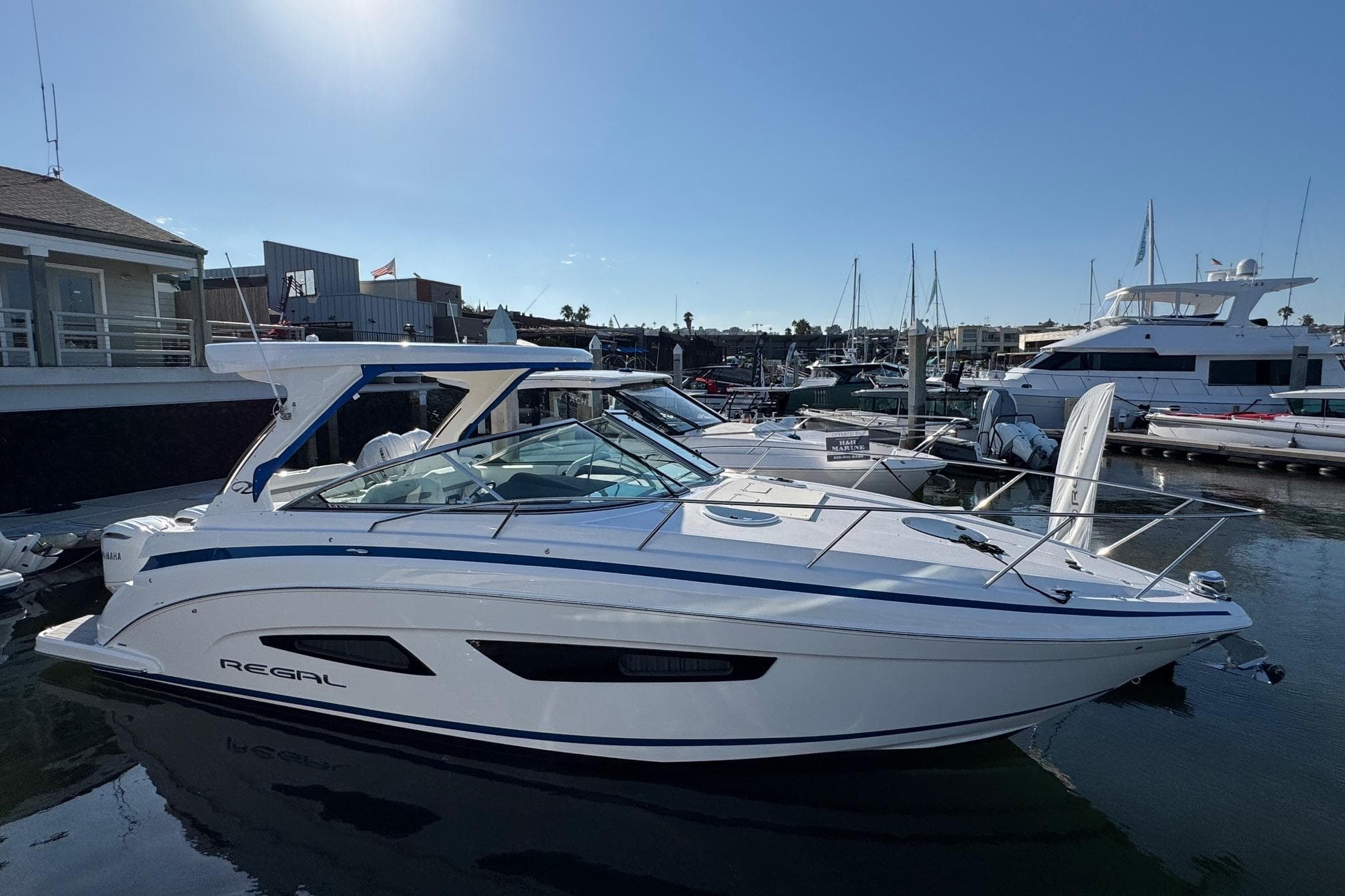 2026 Regal 33 XO boat docked at marina, sleek design, sunny day.