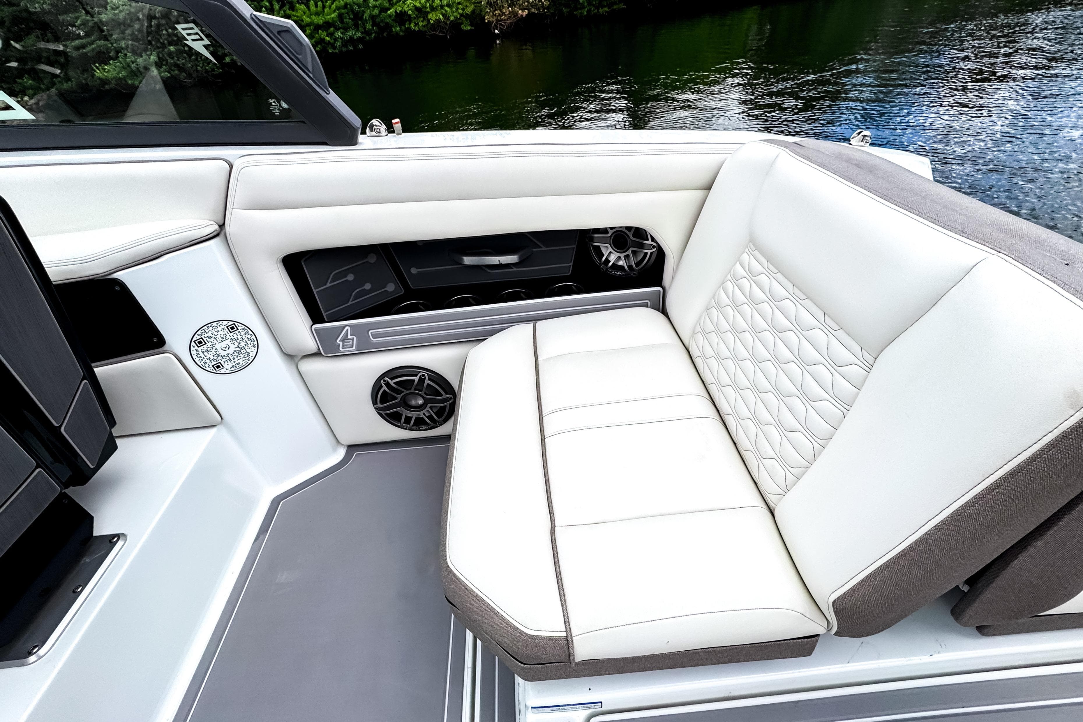 Luxurious seating on 2026 Ingenity EL boat with quilted upholstery and integrated speakers.