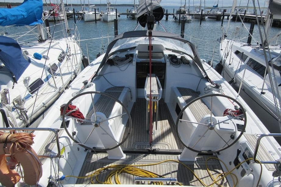 2022 Dehler 34 sailboat cockpit with dual steering wheels, docked at marina.