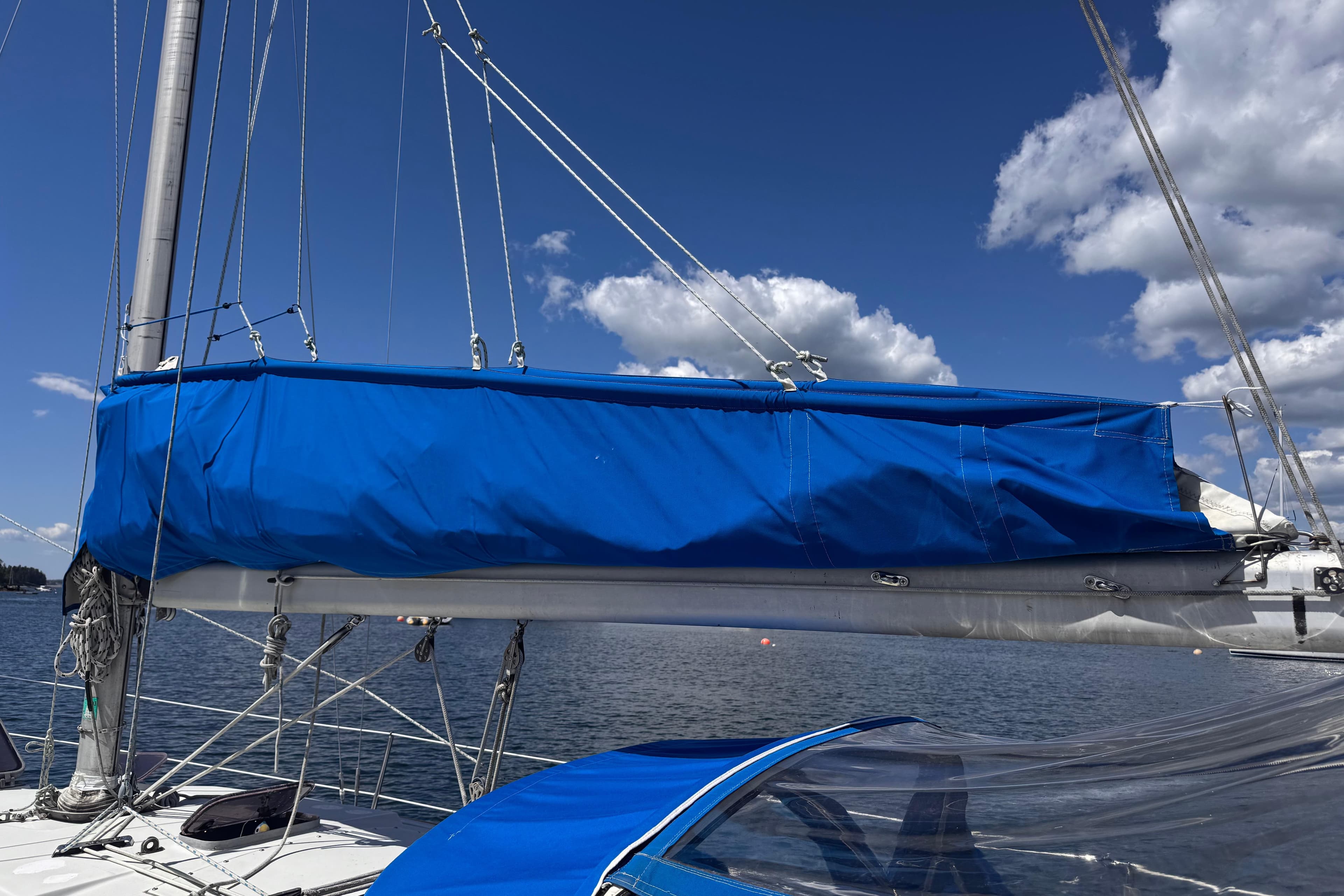 1983 C&C 32 sailboat with blue sail cover on a sunny day.