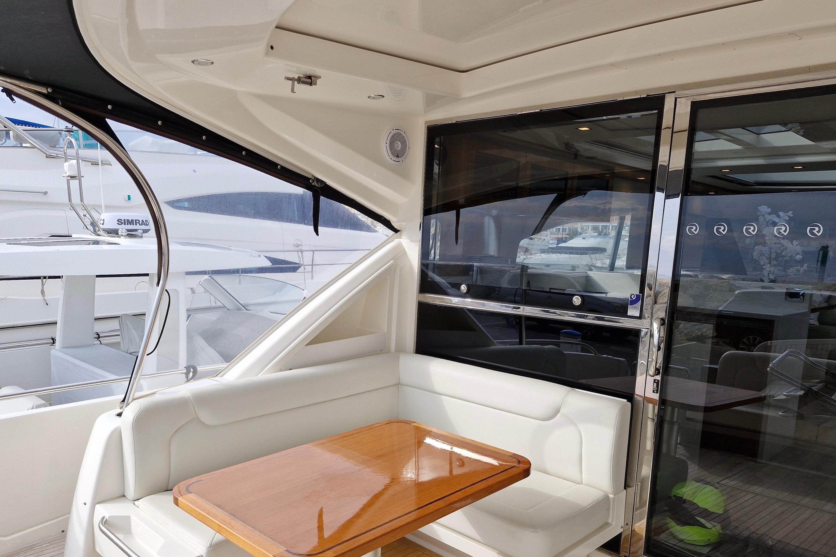 2020 Riviera 6000 Sport Yacht Platinum Edition interior with seating and table.
