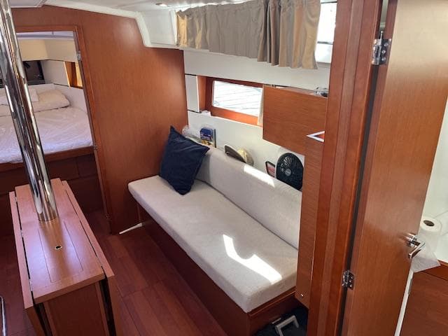 2017 Beneteau Oceanis 38.1 interior with cozy seating and wooden finishes.