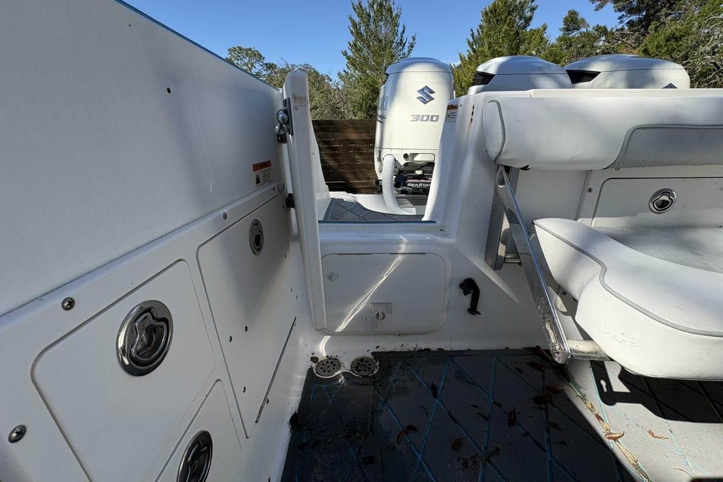 2008 Wellcraft 35 Scarab Sport boat interior with Suzuki 300 engines, white seating, and storage compartments.