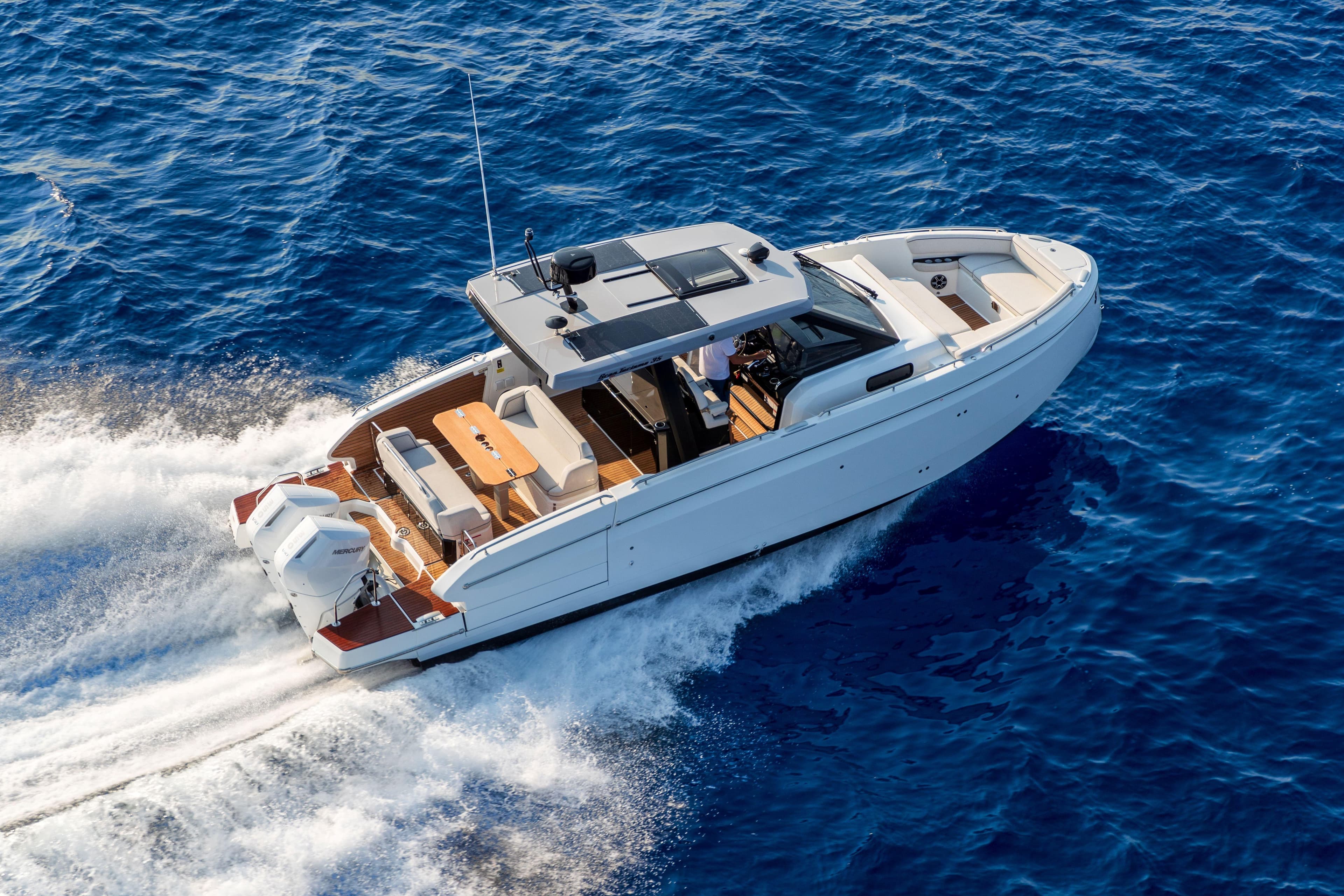 2026 Beneteau Gran Turismo 35 cruising on open blue sea, aerial view.