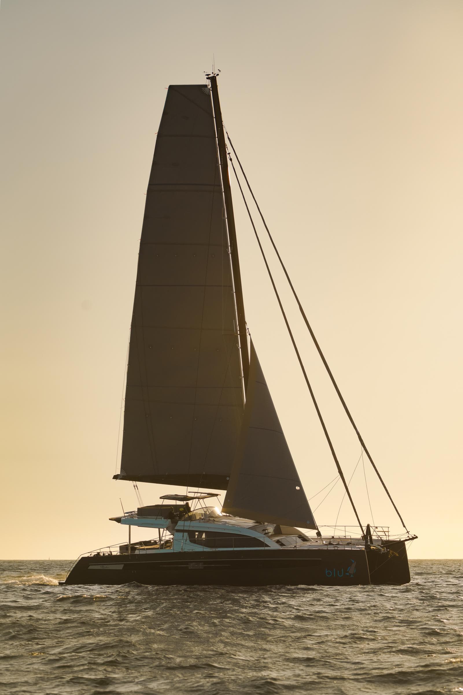 Luxury Privilege Signature 650 catamaran sailing at sunset, 2025 model.