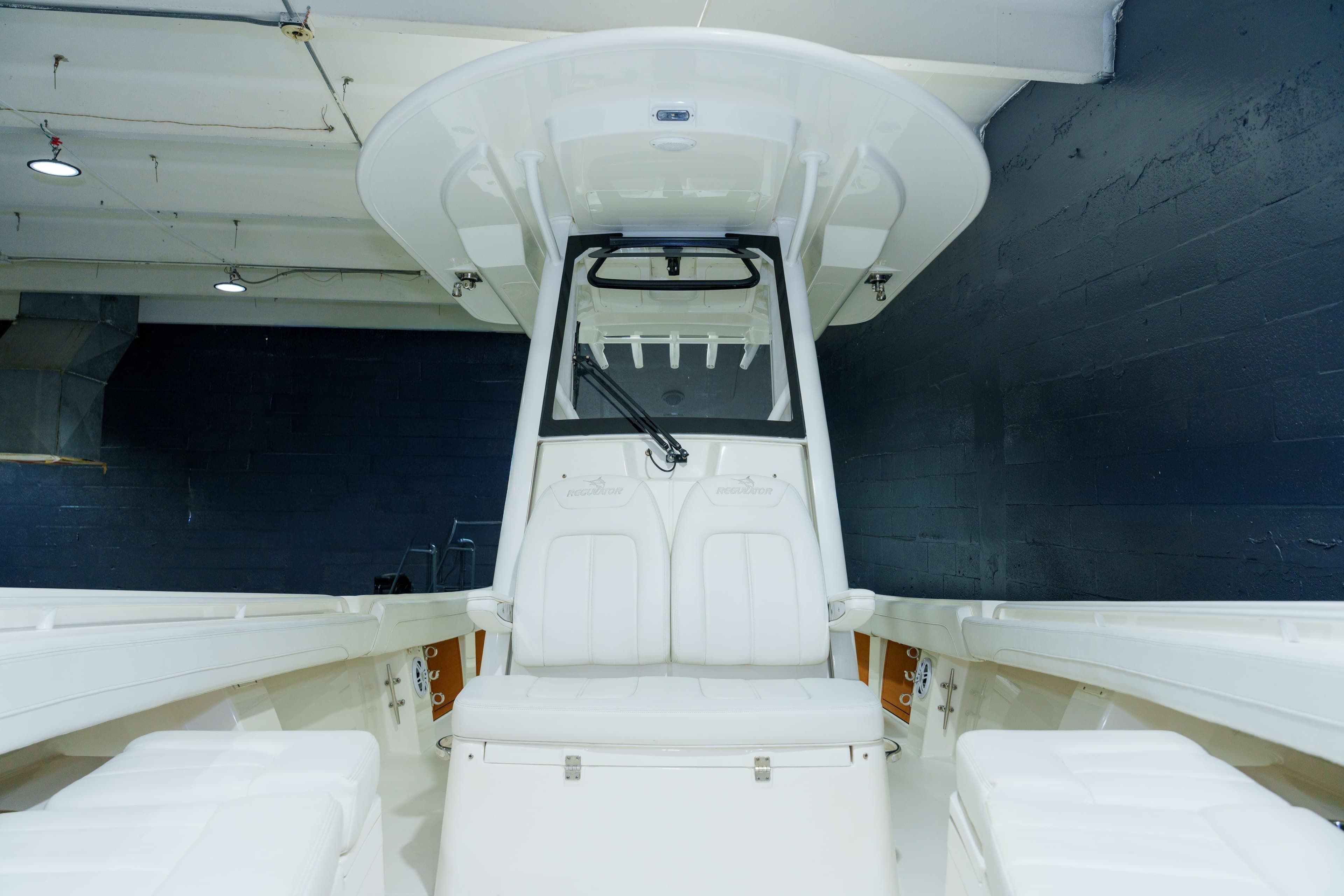 2023 Regulator 28 boat interior with seating and console, displayed indoors.