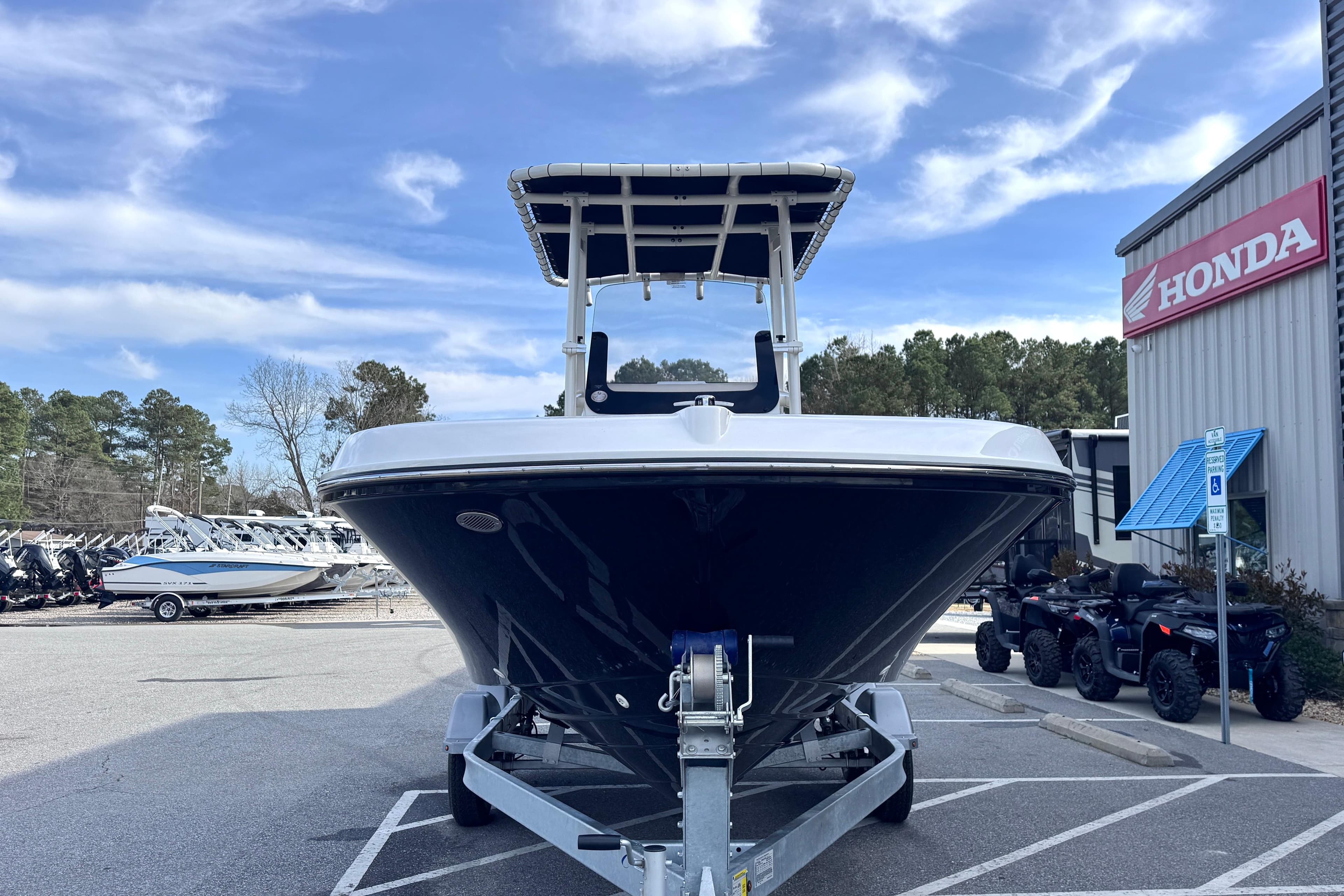 2026 Trophy CC20 boat on trailer, parked near Honda dealership under blue sky.