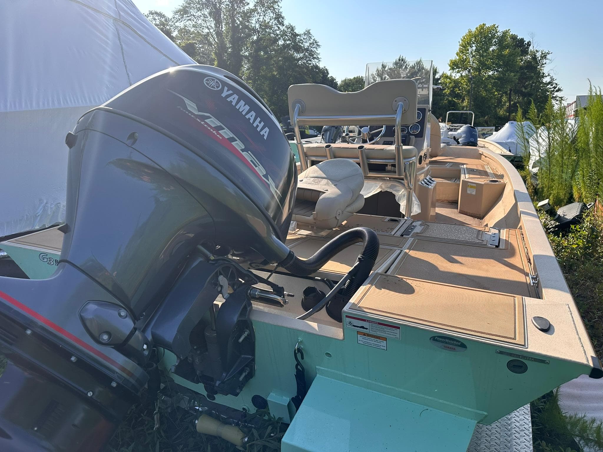 2024 G3 Bay 20 GX boat with Yamaha outboard motor, parked outdoors.