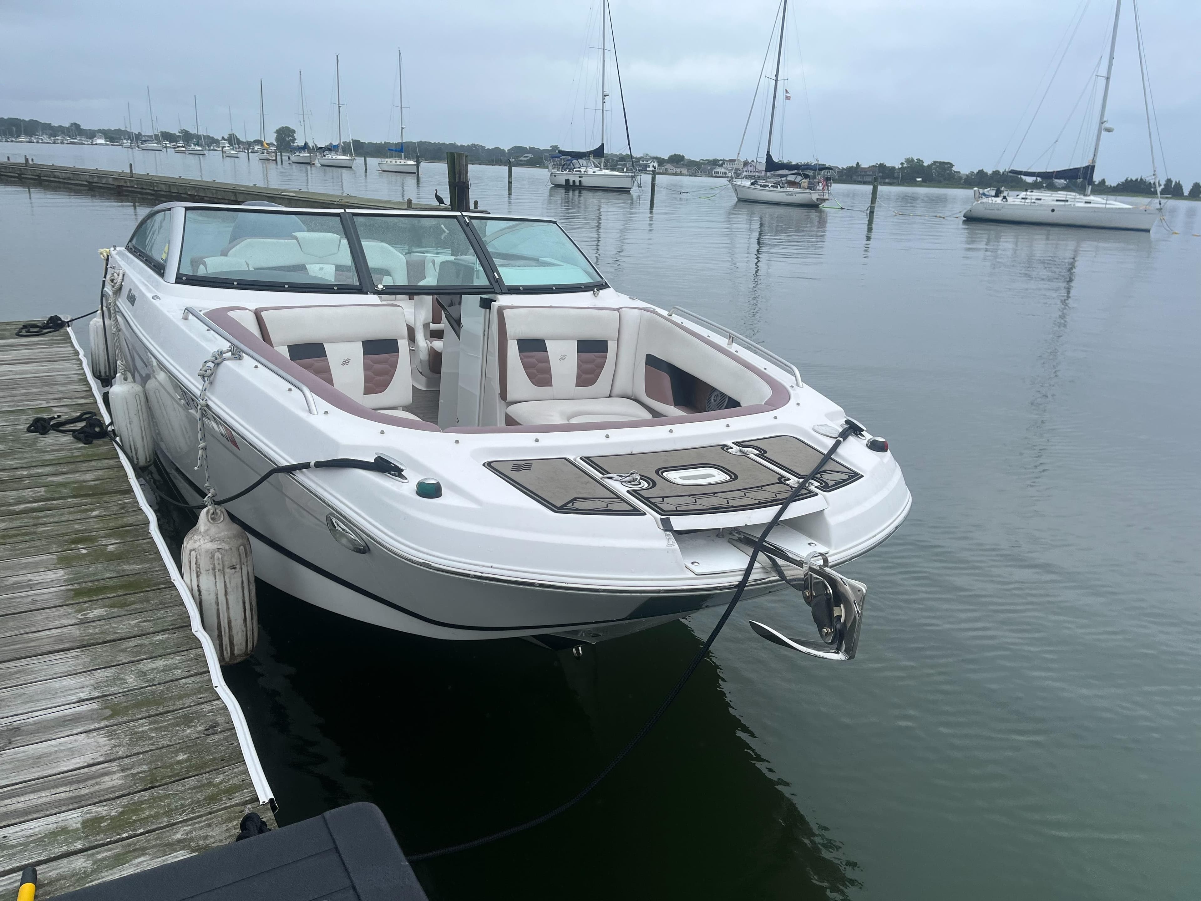 2017 Four Winns 24 Bow Rider boat docked at a marina.