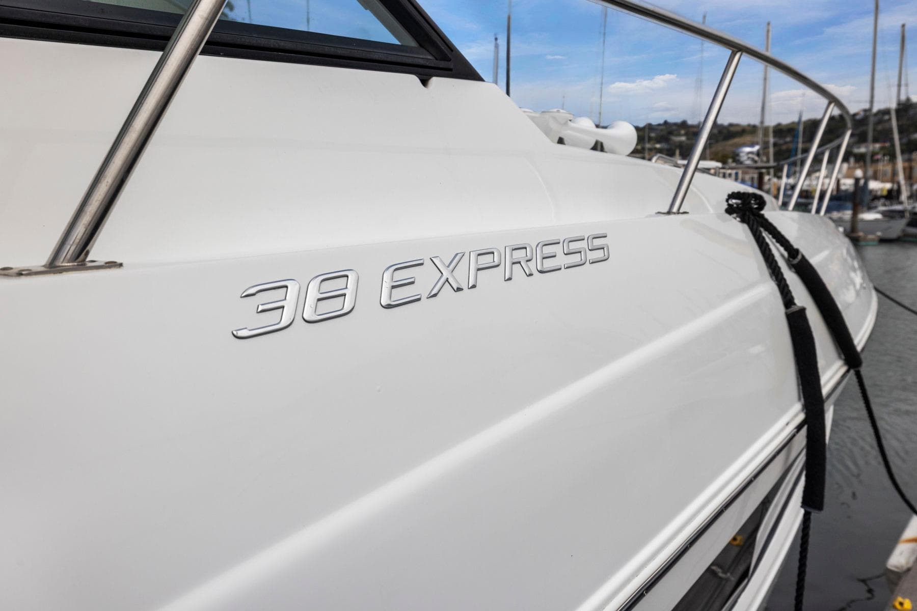 2019 Cruisers Yachts 38 Express boat docked, showcasing sleek design and branding.