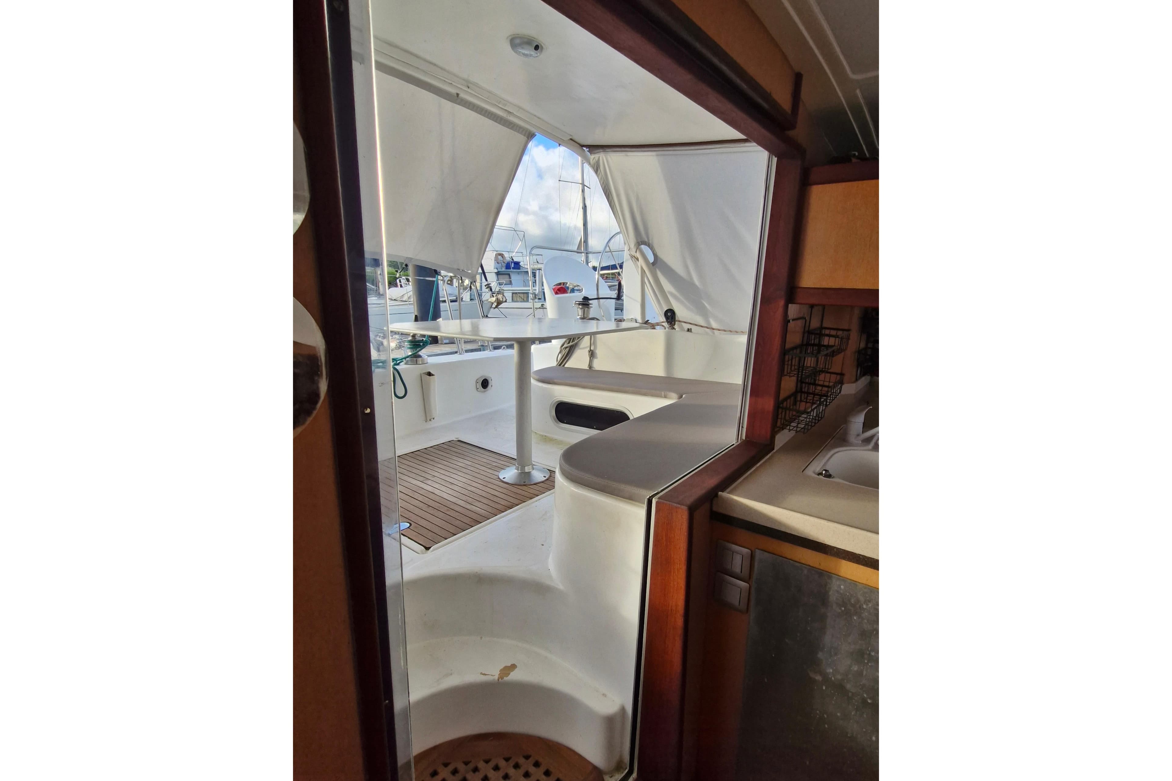 Interior view of a 2001 Catana 401 catamaran, showcasing the cockpit and seating area.