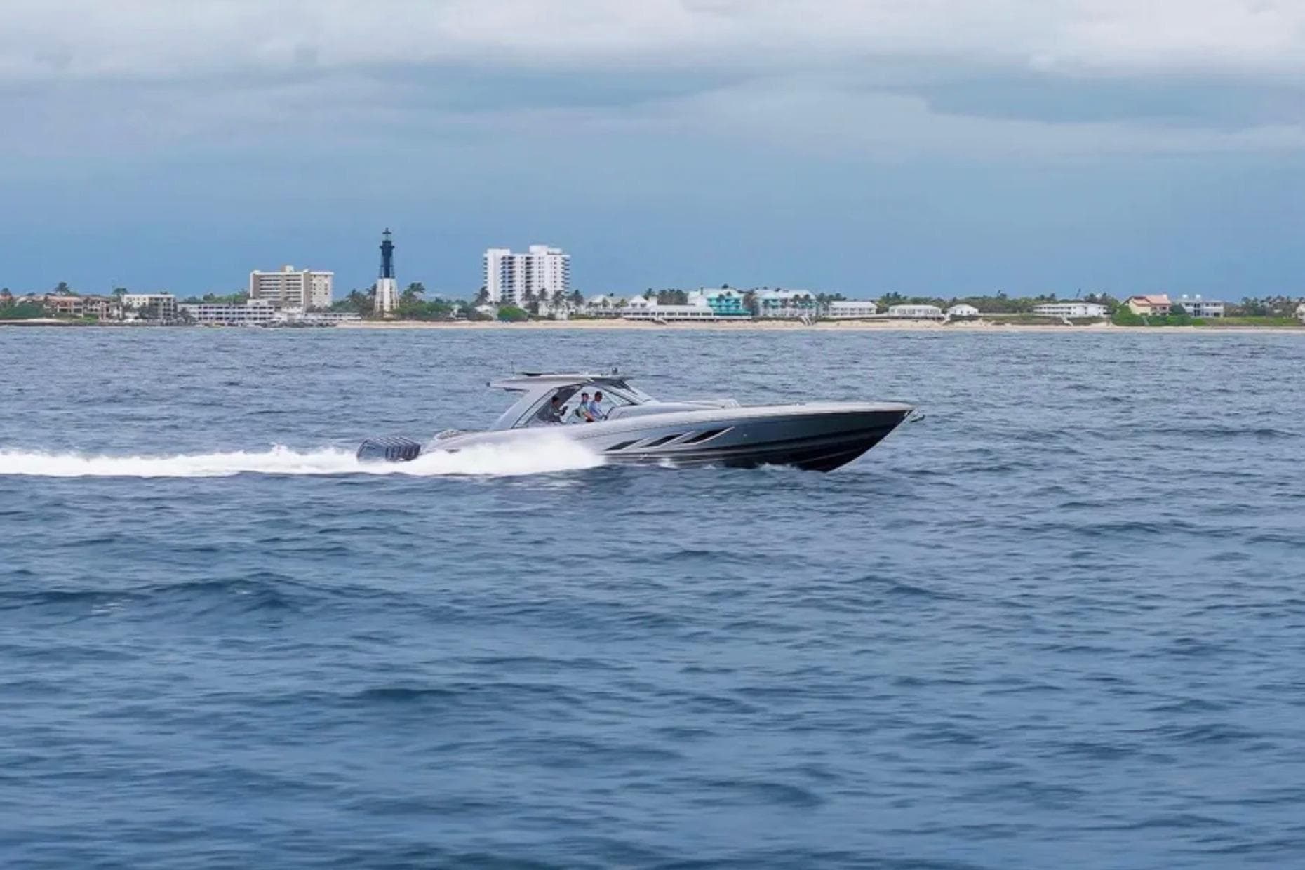 2026 Deep Impact 499 Sport speedboat cruising near coastal cityscape.