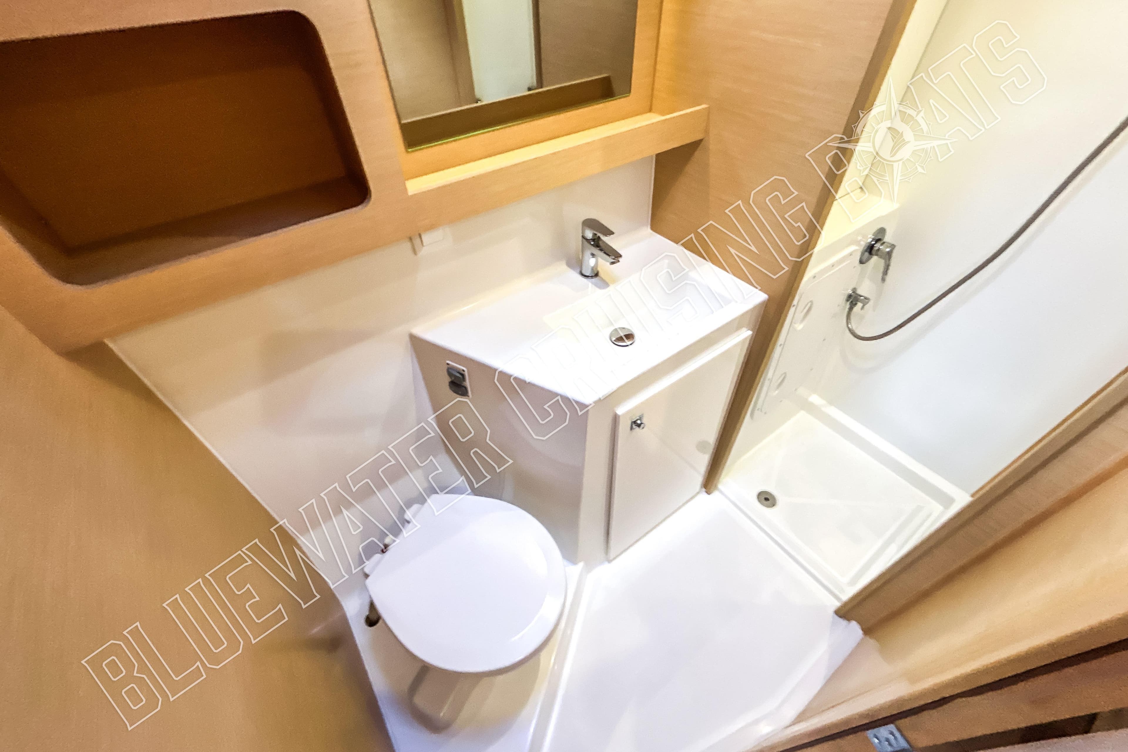Bathroom interior of 2018 Lagoon 42 yacht with shower, sink, and toilet.