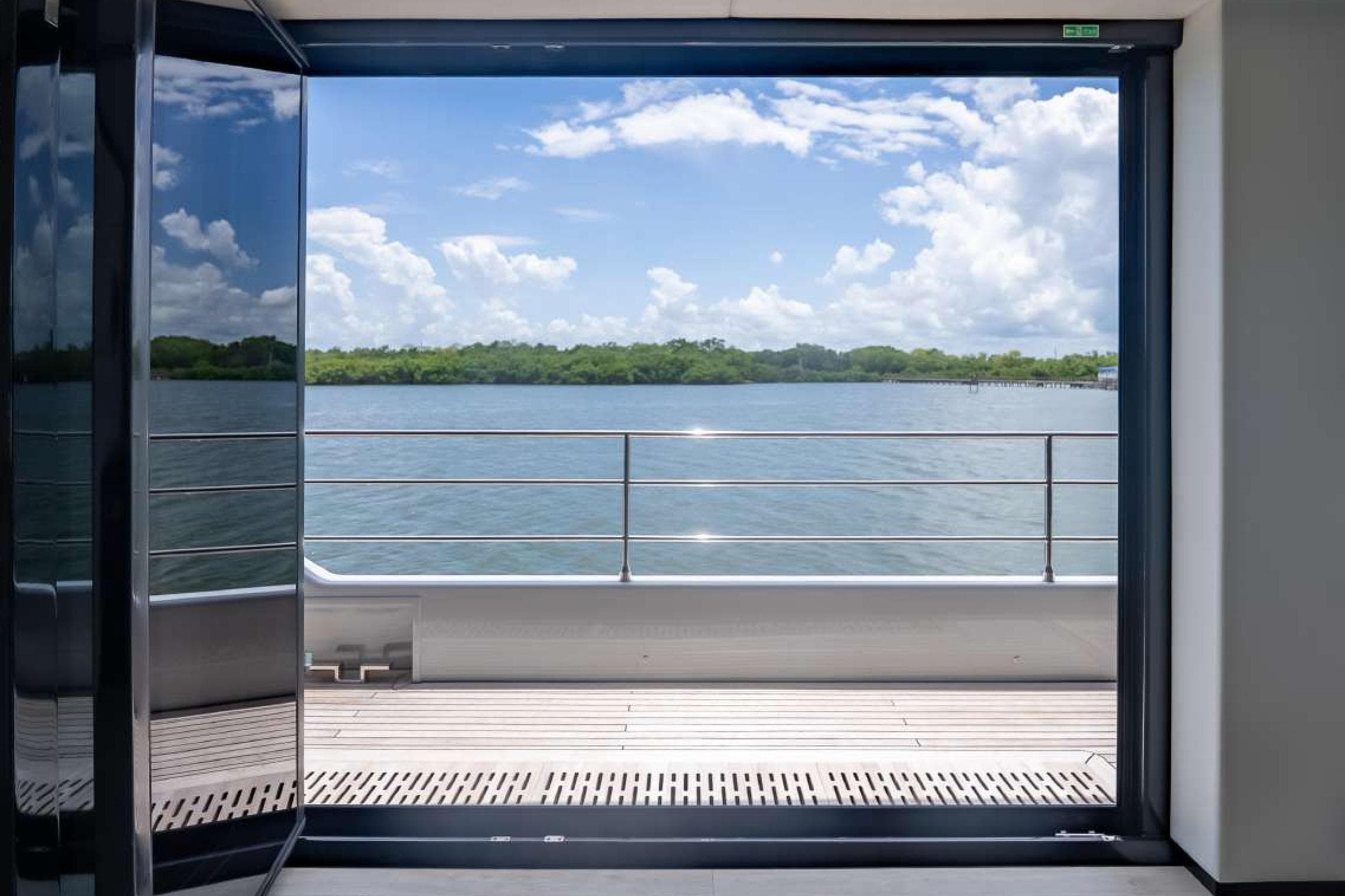 View from Sunreef Supreme 68 Power yacht, showcasing serene waters and lush greenery.