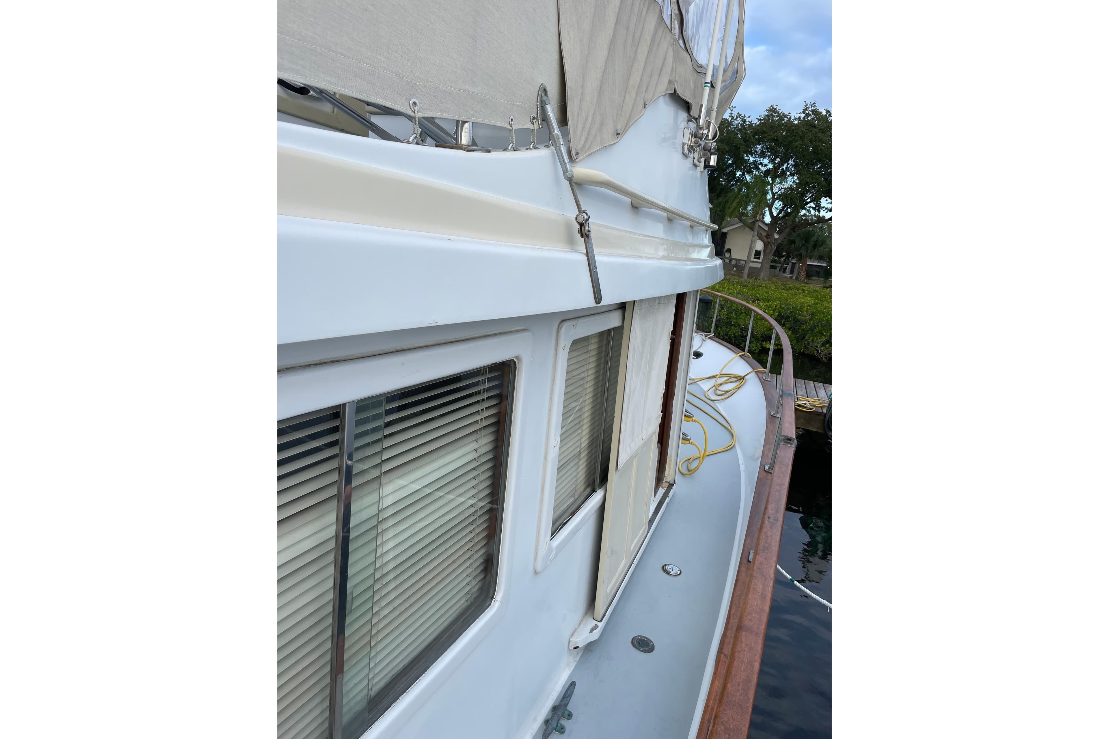 1987 Albin 36 Trawler side deck view with windows and railing.