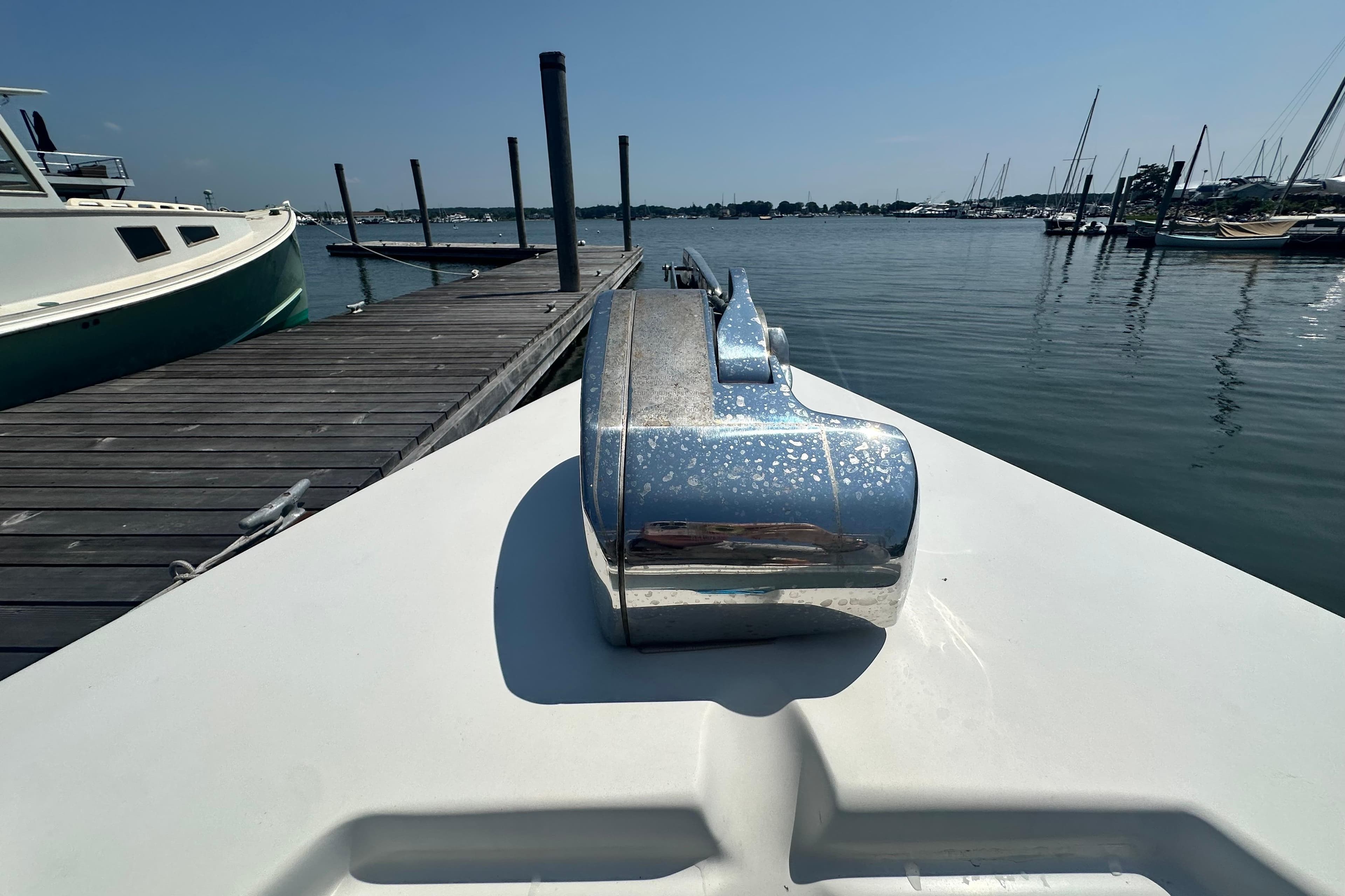 Bow of 2007 Custom Venet Vision 2 boat docked at marina, sunny day.