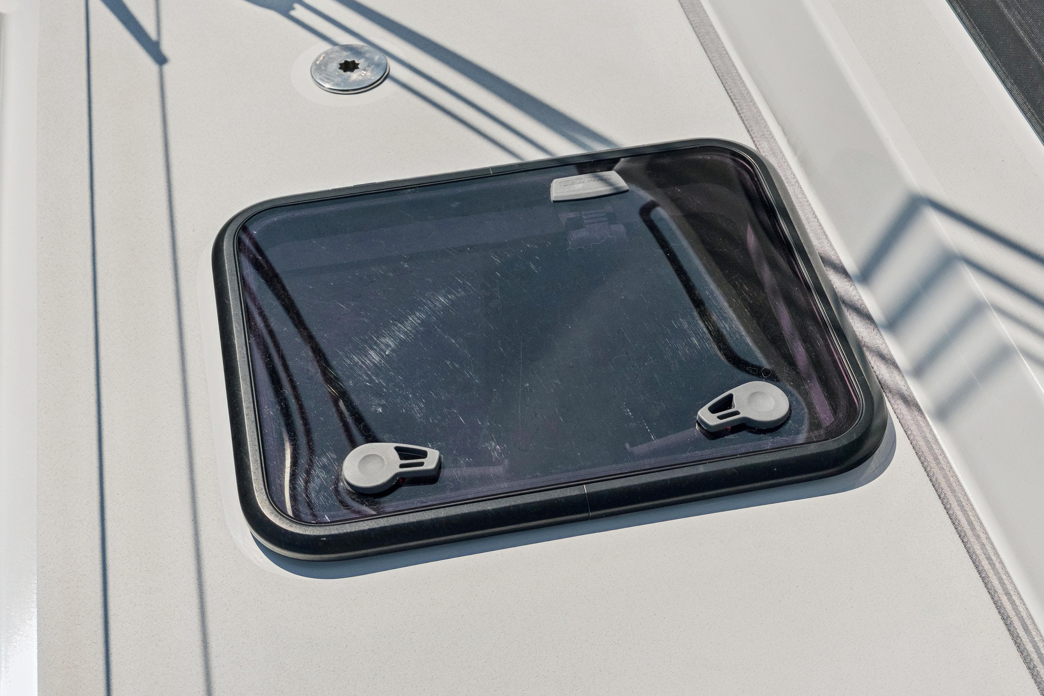 Hatch window on 2024 St Francis 460 yacht deck, featuring sleek design and secure latches.