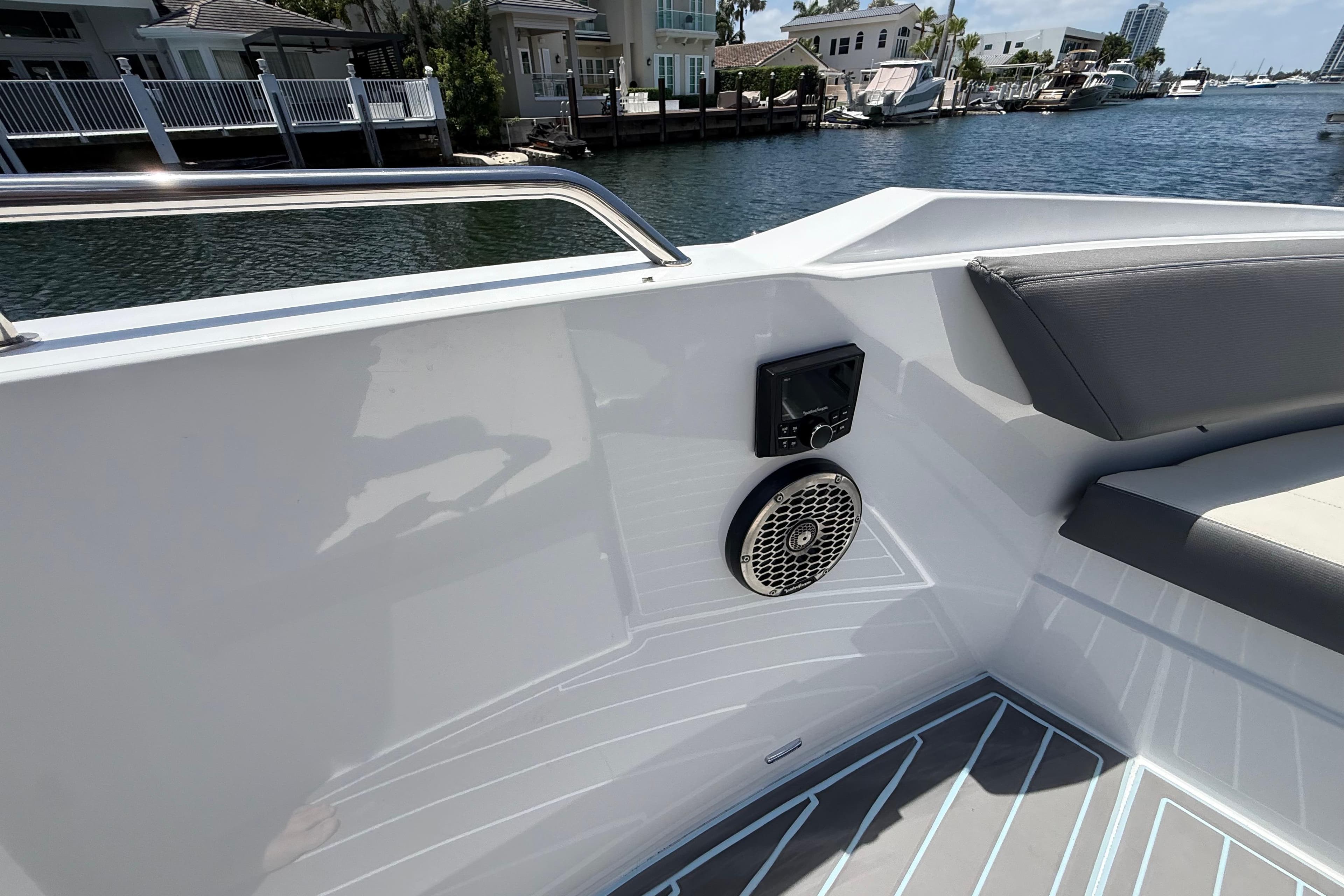 2021 Cruisers Yachts 38 GLS OB interior with speaker and seating, dockside view.