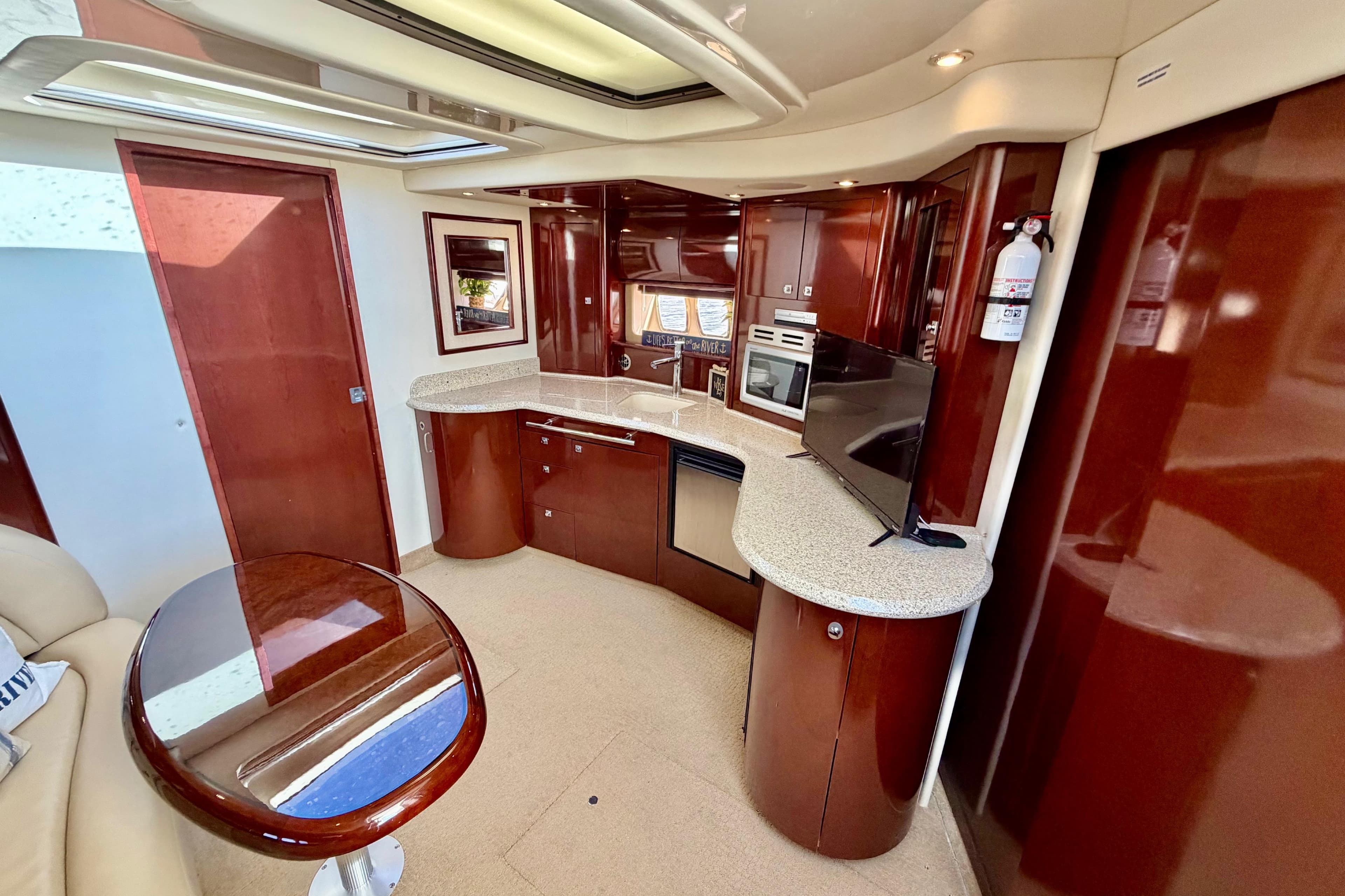 Luxurious interior of 2008 Sea Ray 44 Sundancer yacht with modern kitchen amenities.