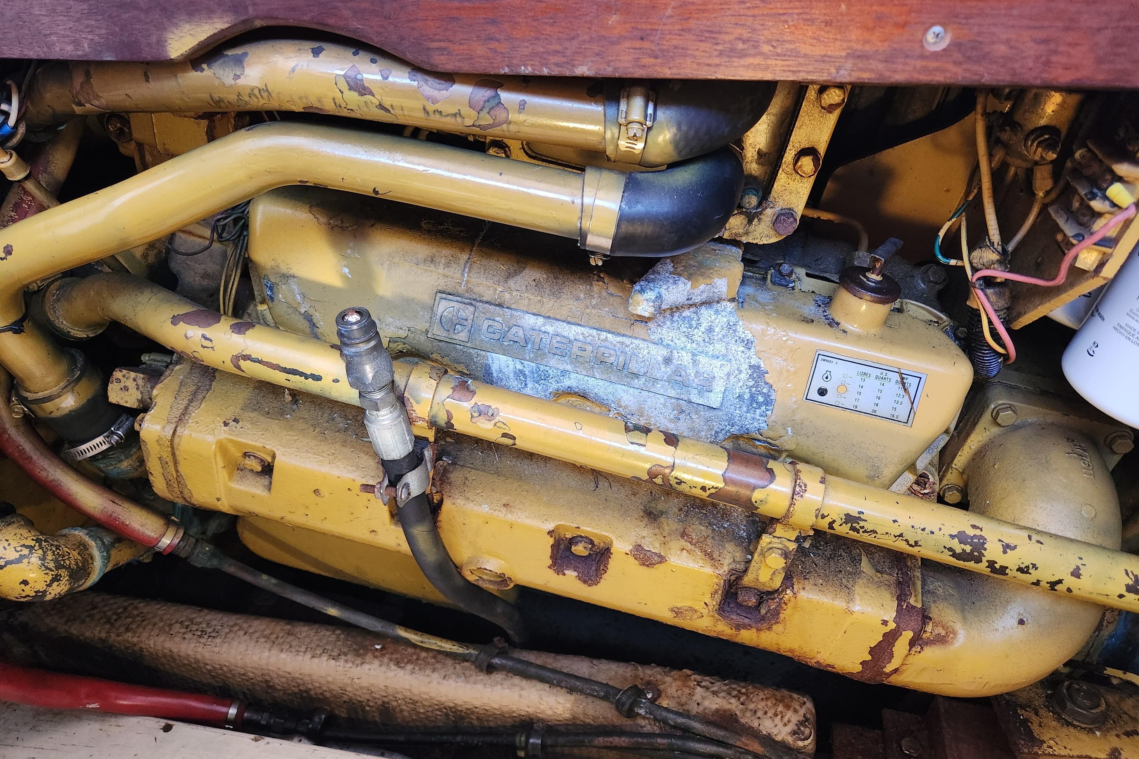 Engine compartment of a 1987 Luhrs 40 Convertible boat, featuring a Caterpillar engine.