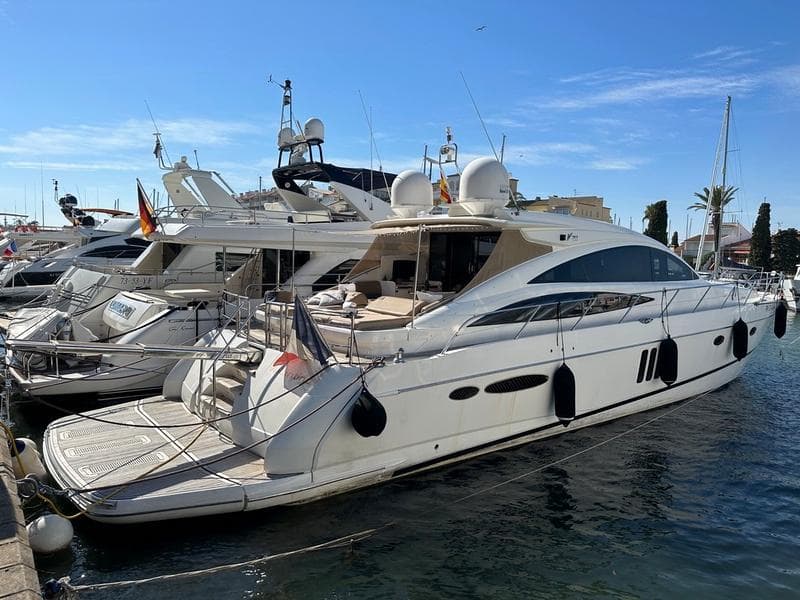Luxury 2007 Princess V70 yacht docked in marina under clear blue sky.
