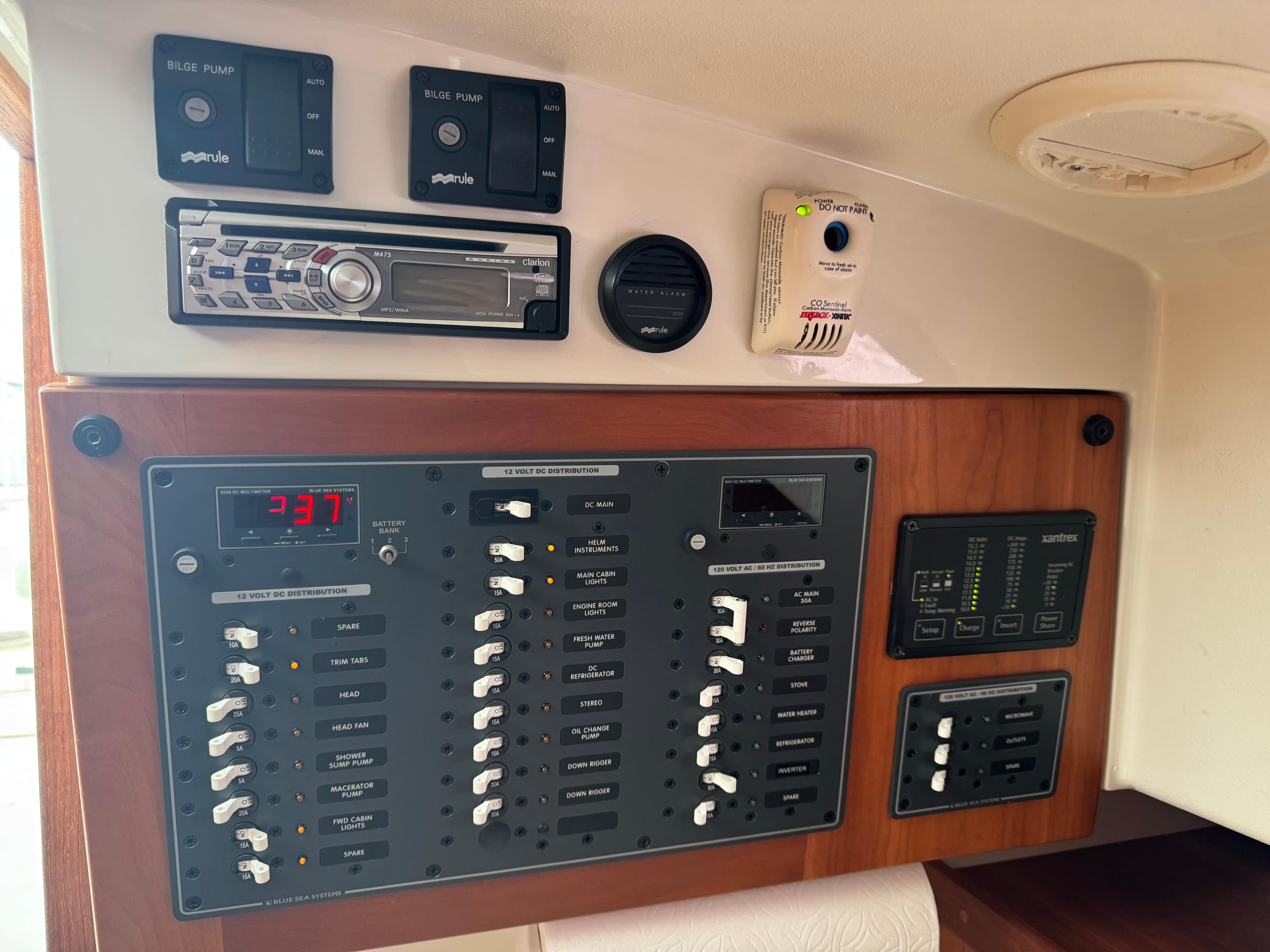 Electrical control panel of a 2008 Back Cove 29 Hardback boat, featuring switches and stereo system.