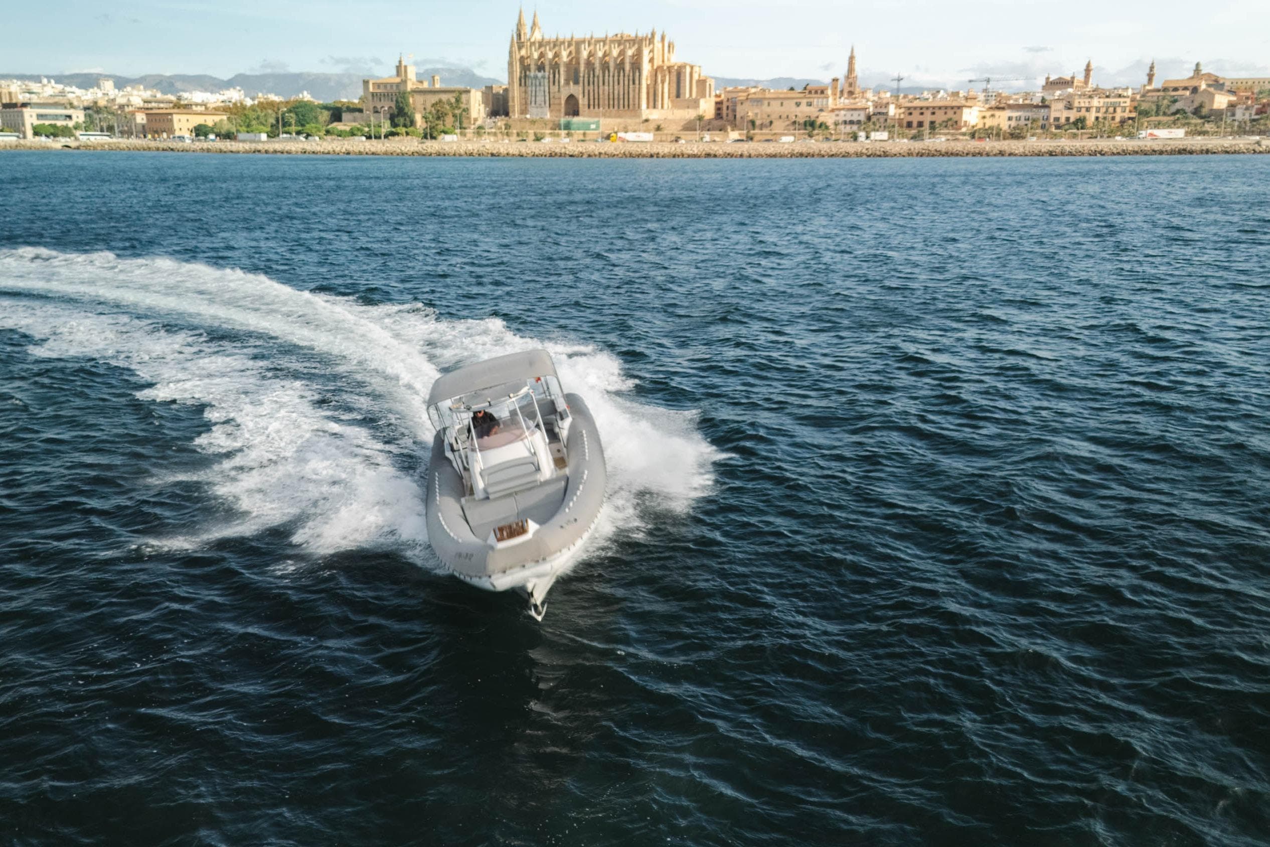 2007 SACS Stratos S42 boat cruising near historic coastal cityscape.