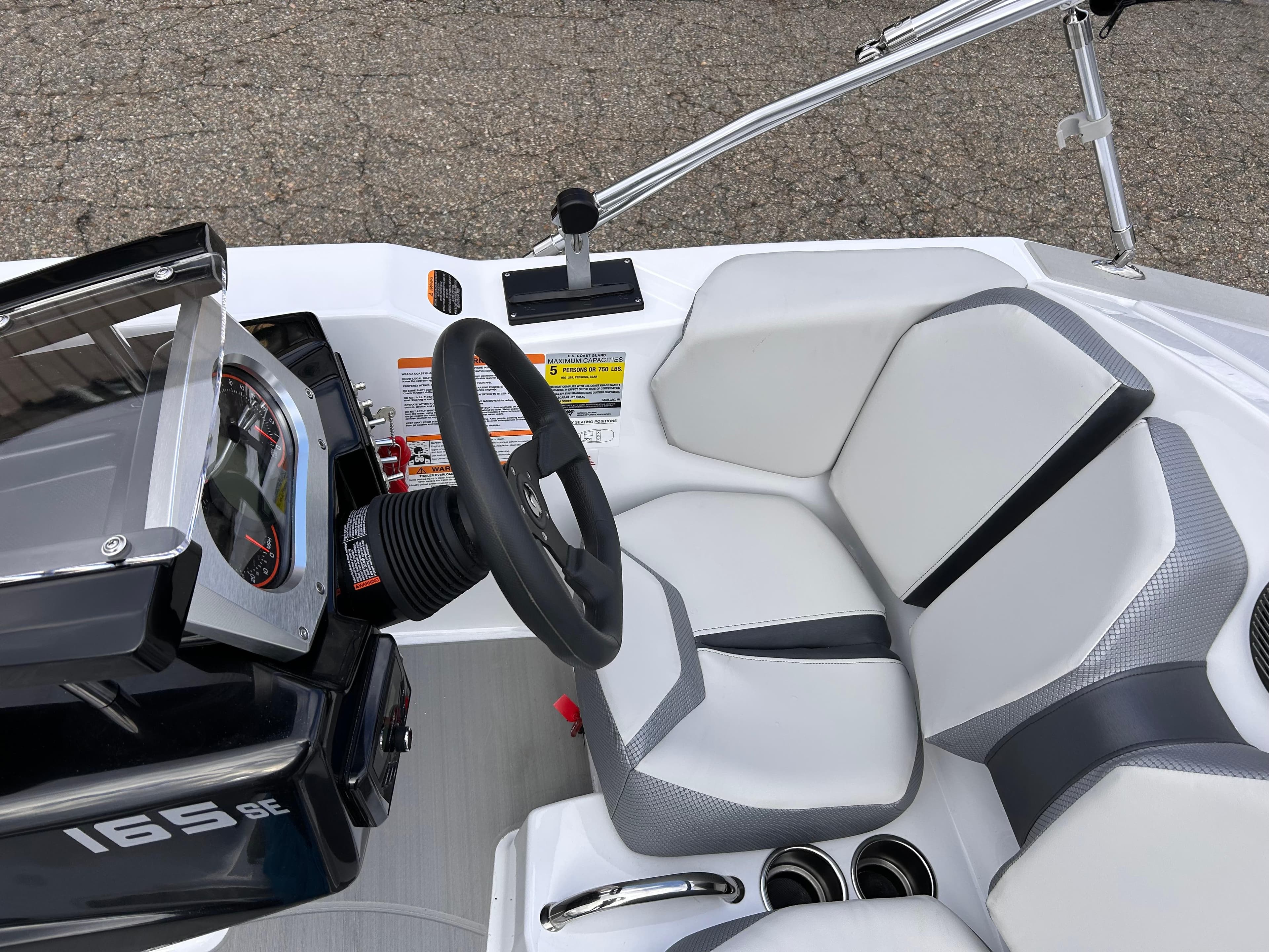 2025 Scarab 165 SE boat interior with steering wheel and seating.