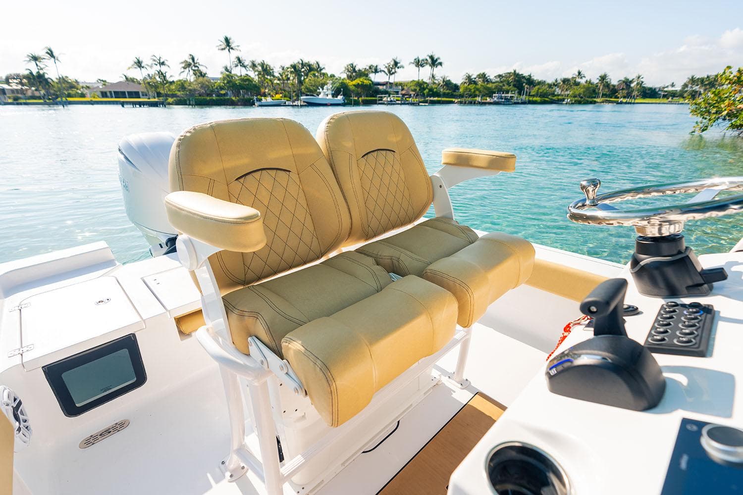 Manufacturer Provided Image: 2025 Sportsman Masters 227 Bay Boat interior with tan seats, steering wheel, and water view.