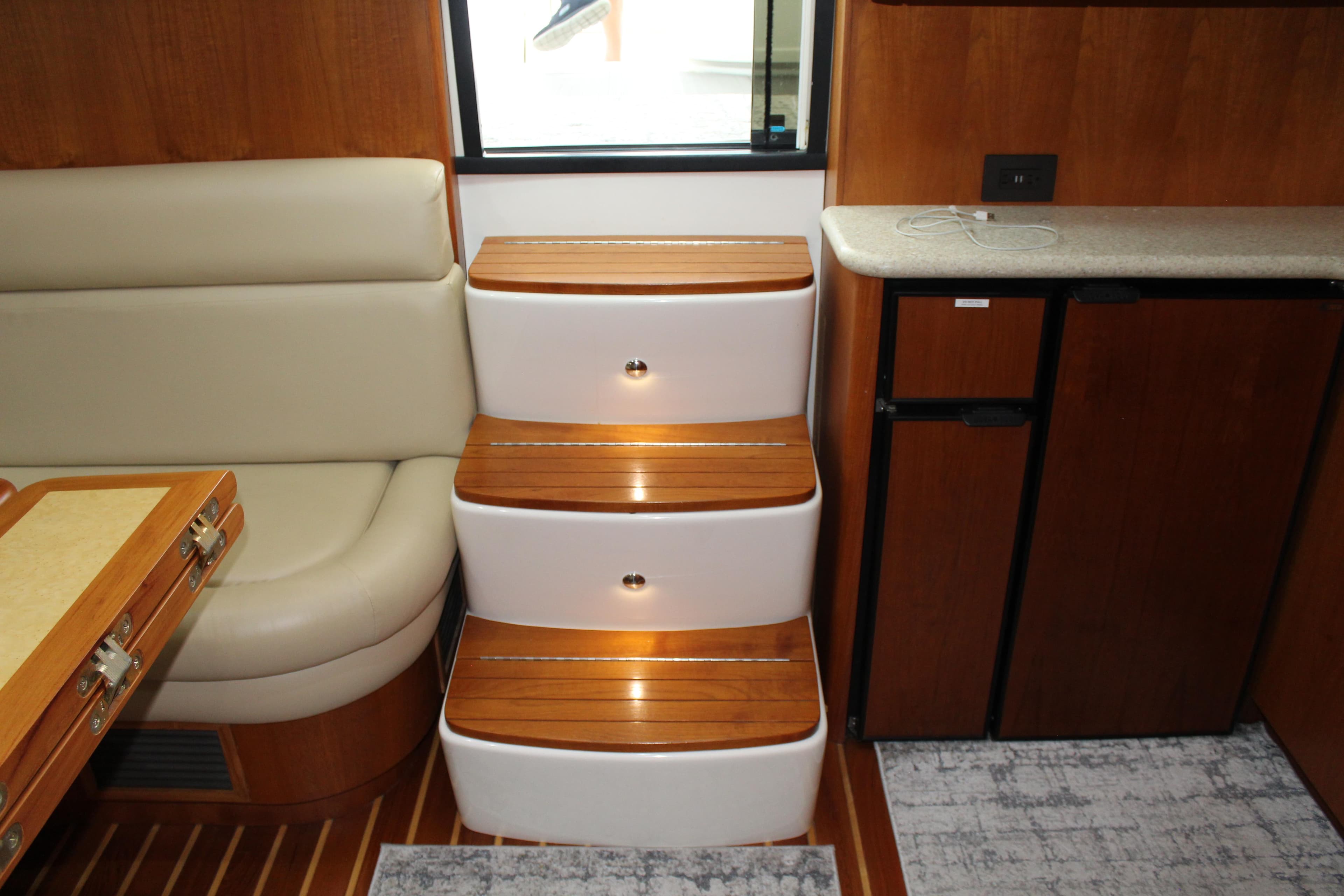 Interior of 2002 Tiara Yachts 3800 Open with wooden steps and seating.