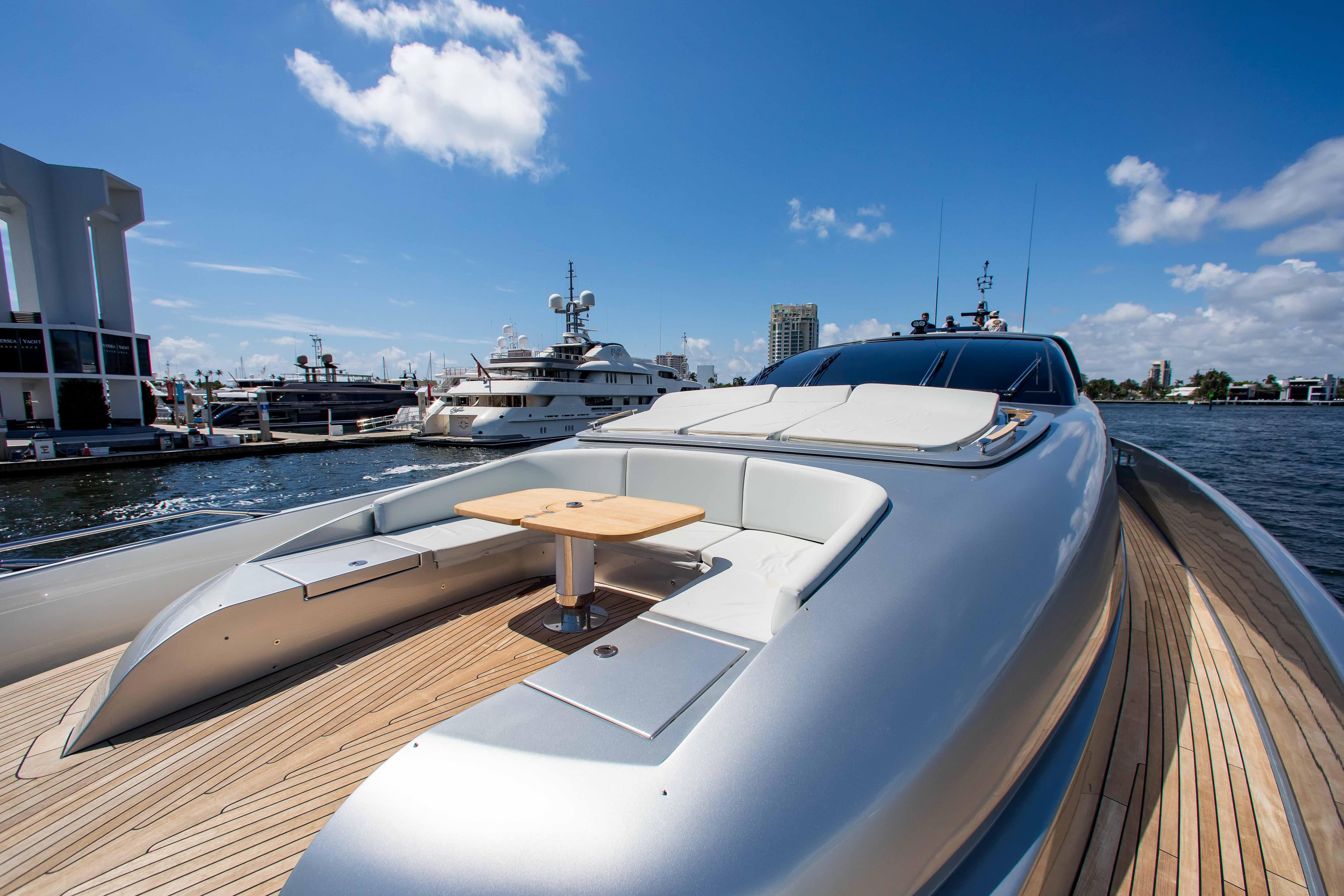 2014 Riva Mythos Motoryacht docked, featuring sleek design and luxurious deck seating.